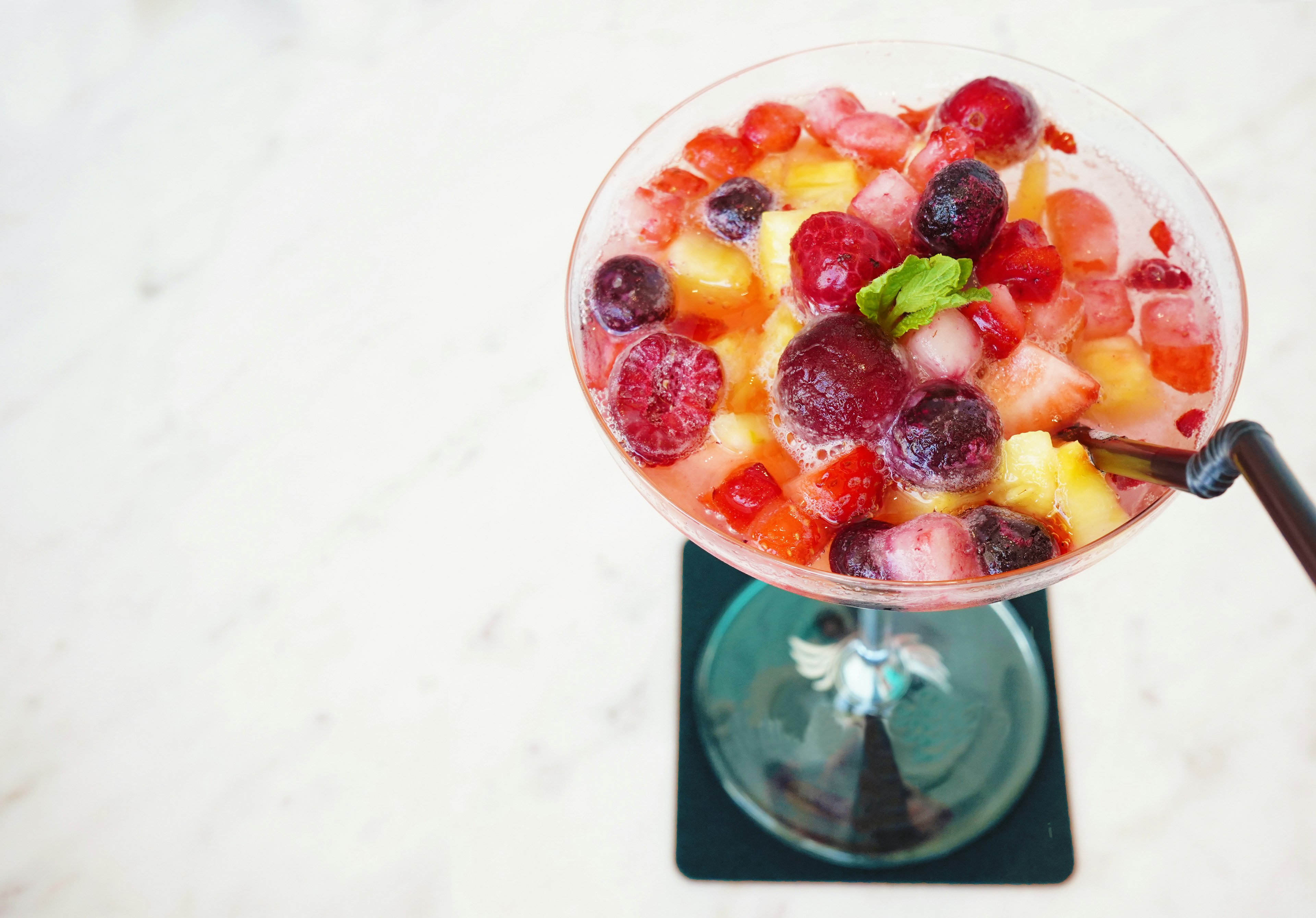 Colorful fruit cocktail in a glass viewed from above