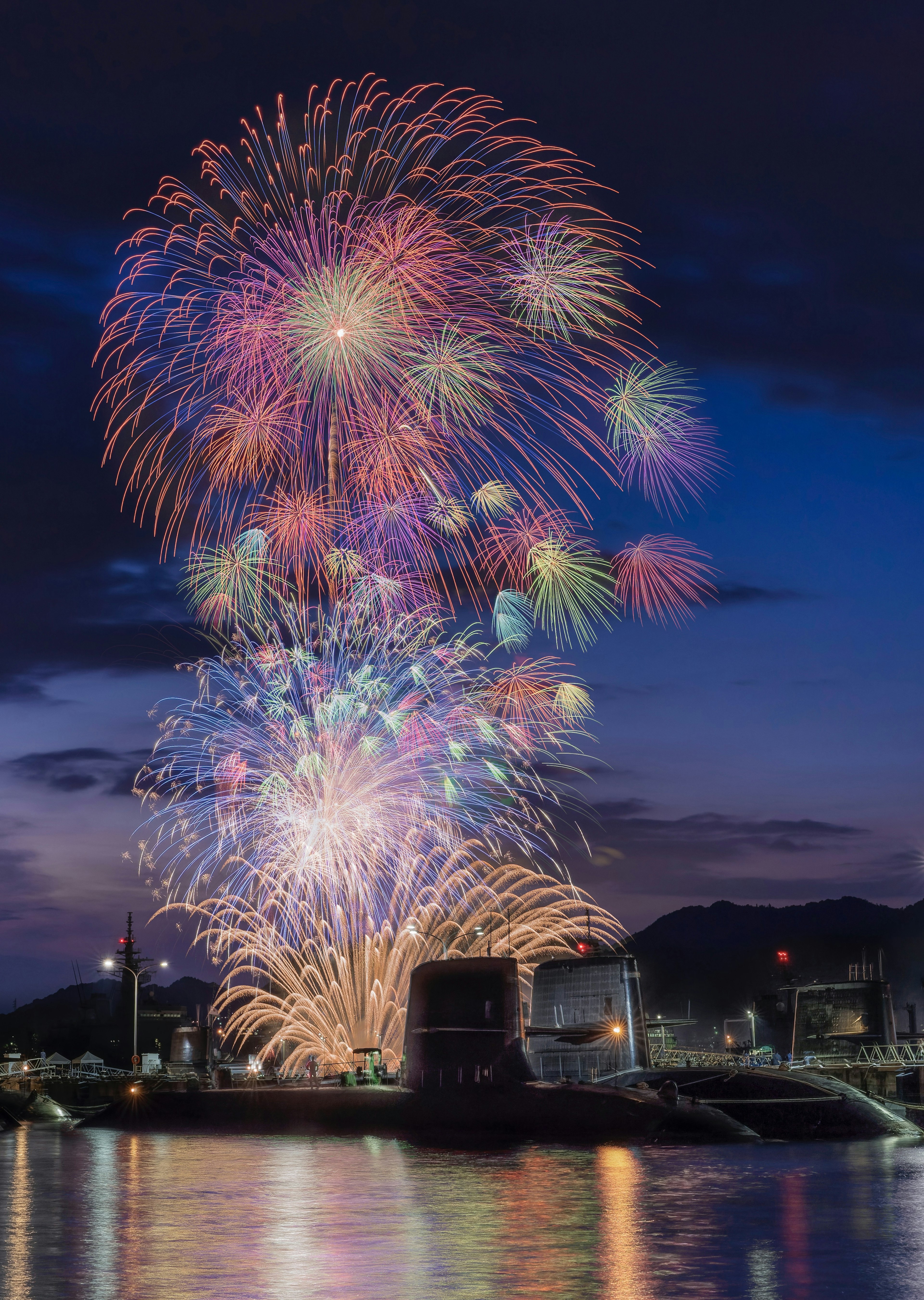 Hermoso espectáculo de fuegos artificiales en el cielo nocturno sobre el agua