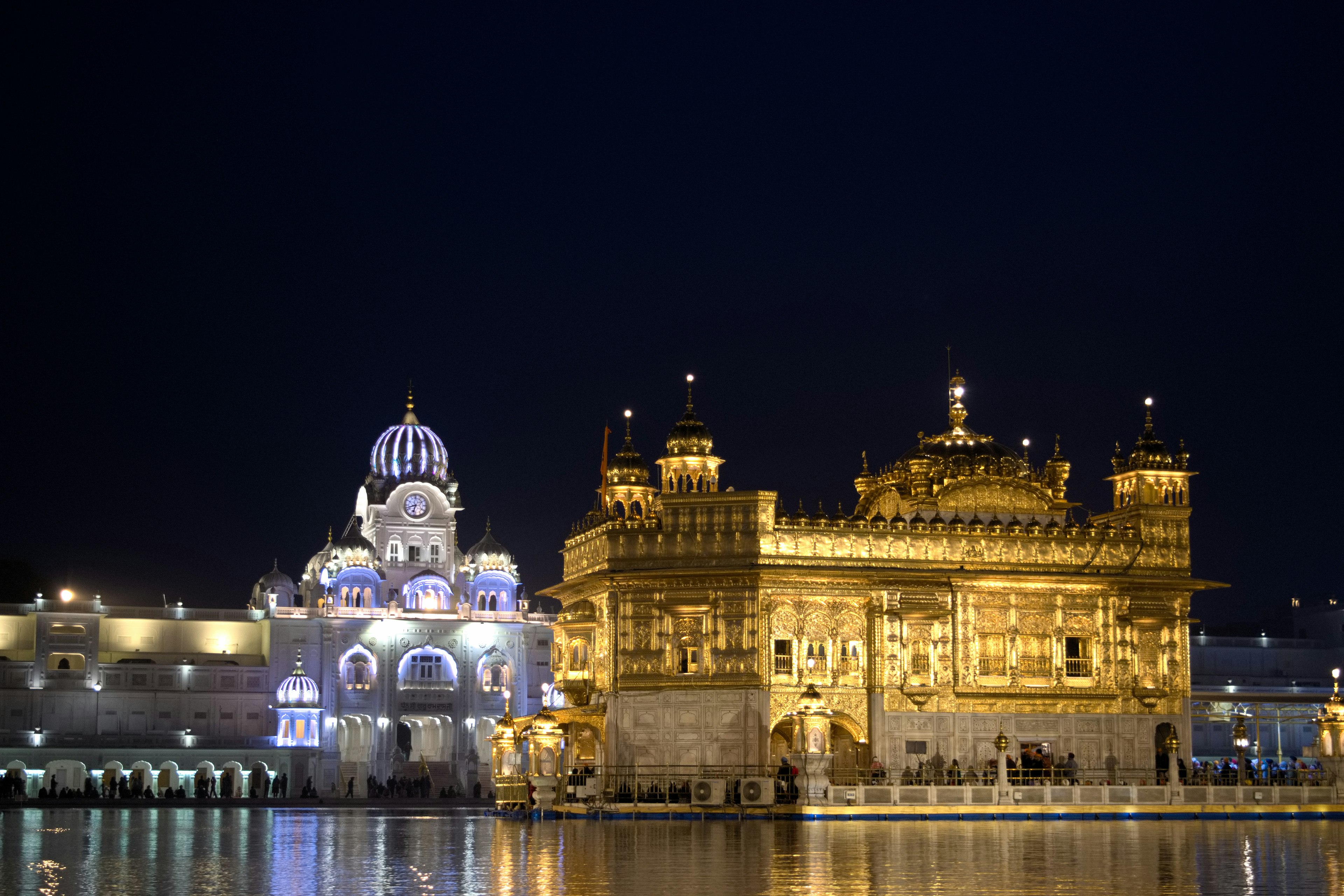 Beautiful scene of the golden temple at night reflecting in the water