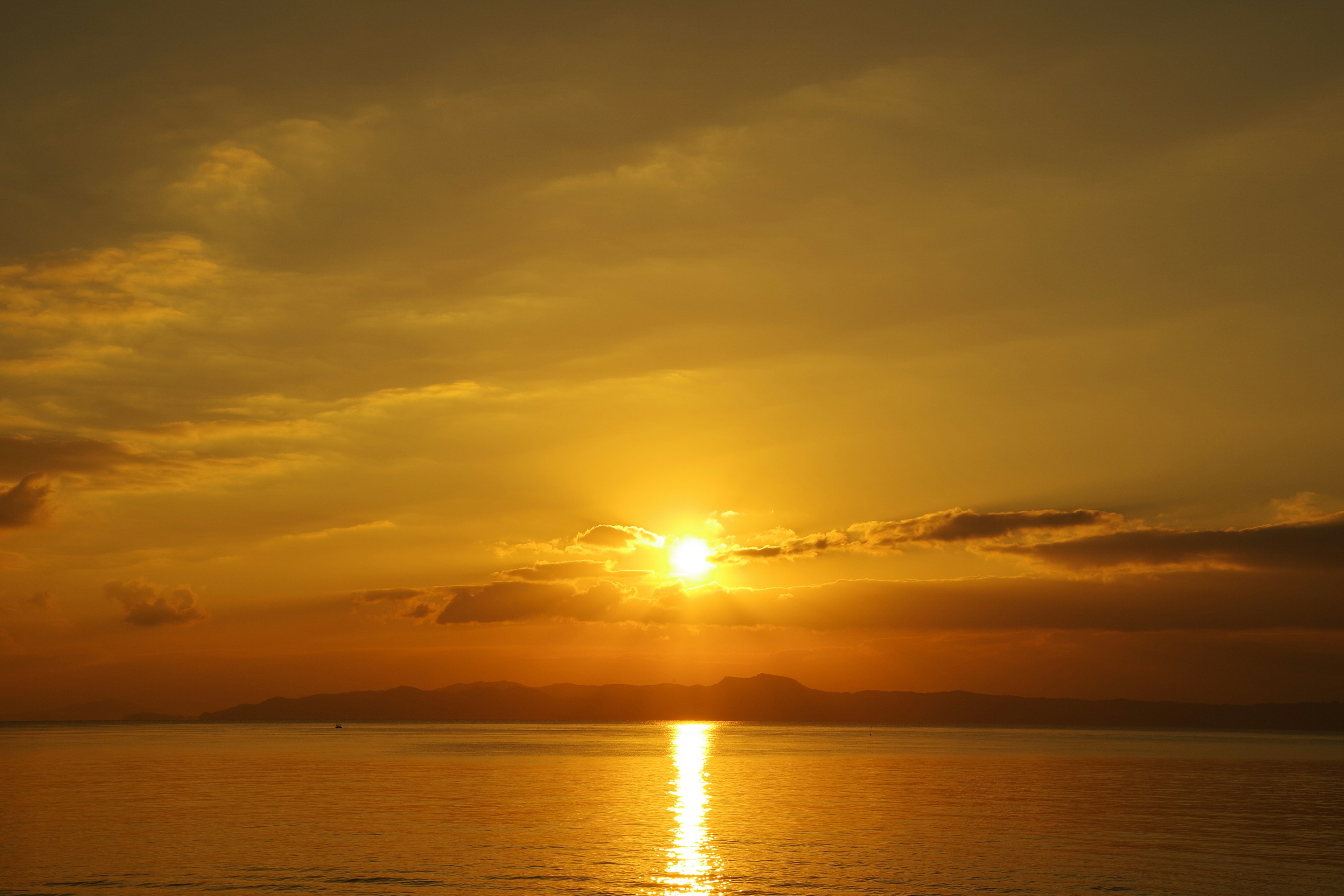 Sunset over the ocean with golden hues