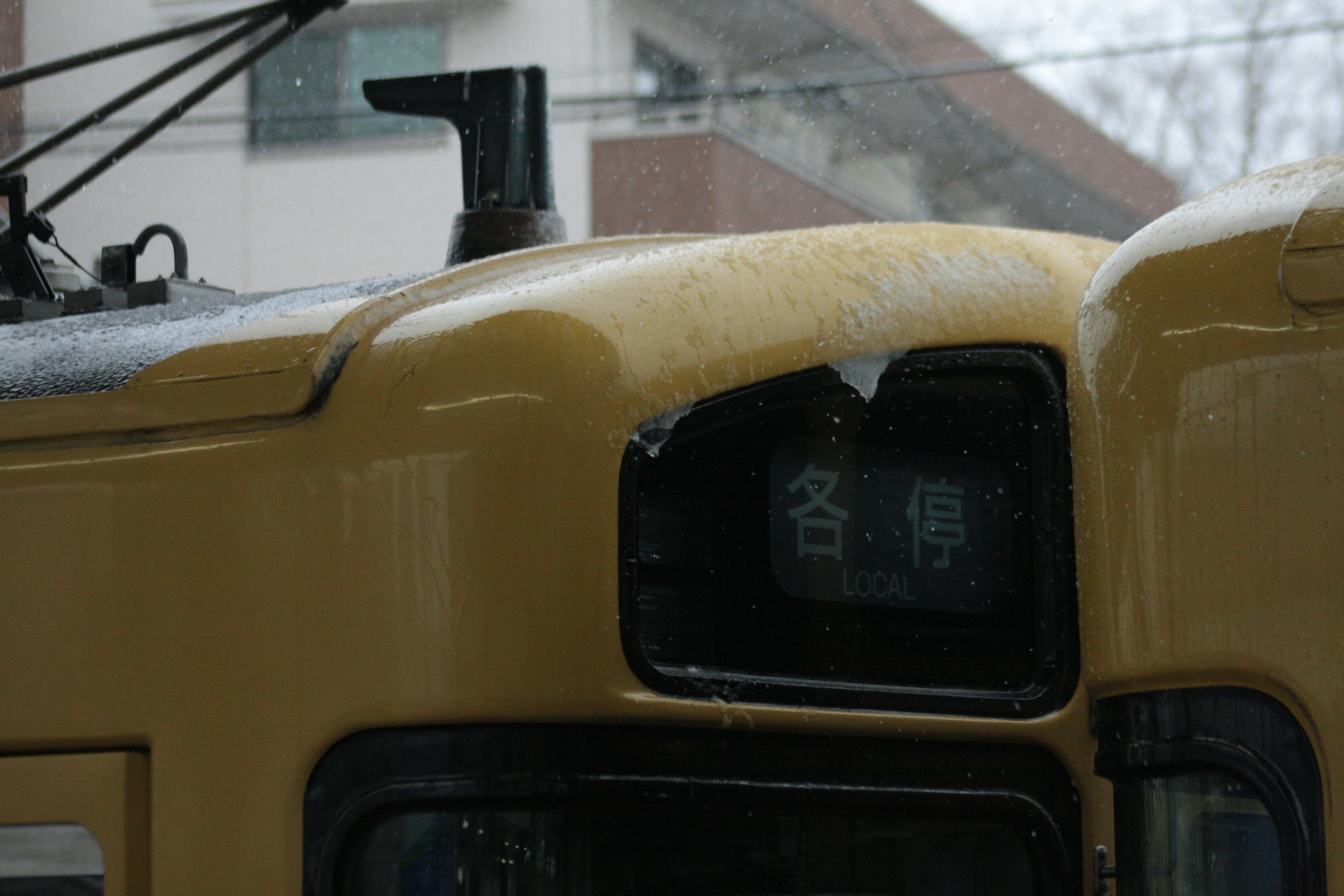 Yellow train front display in the snow