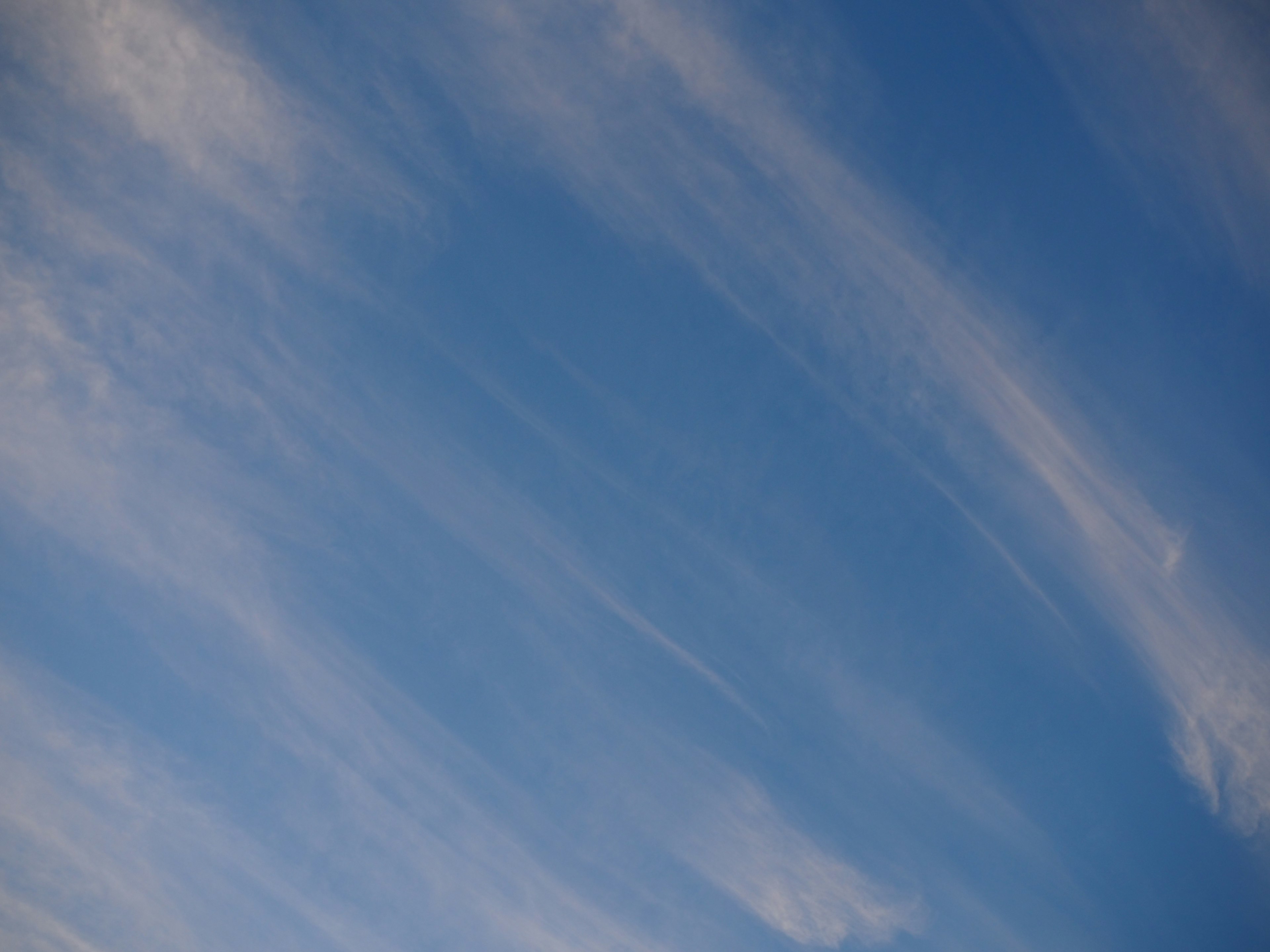 Streaks of white clouds against a blue sky