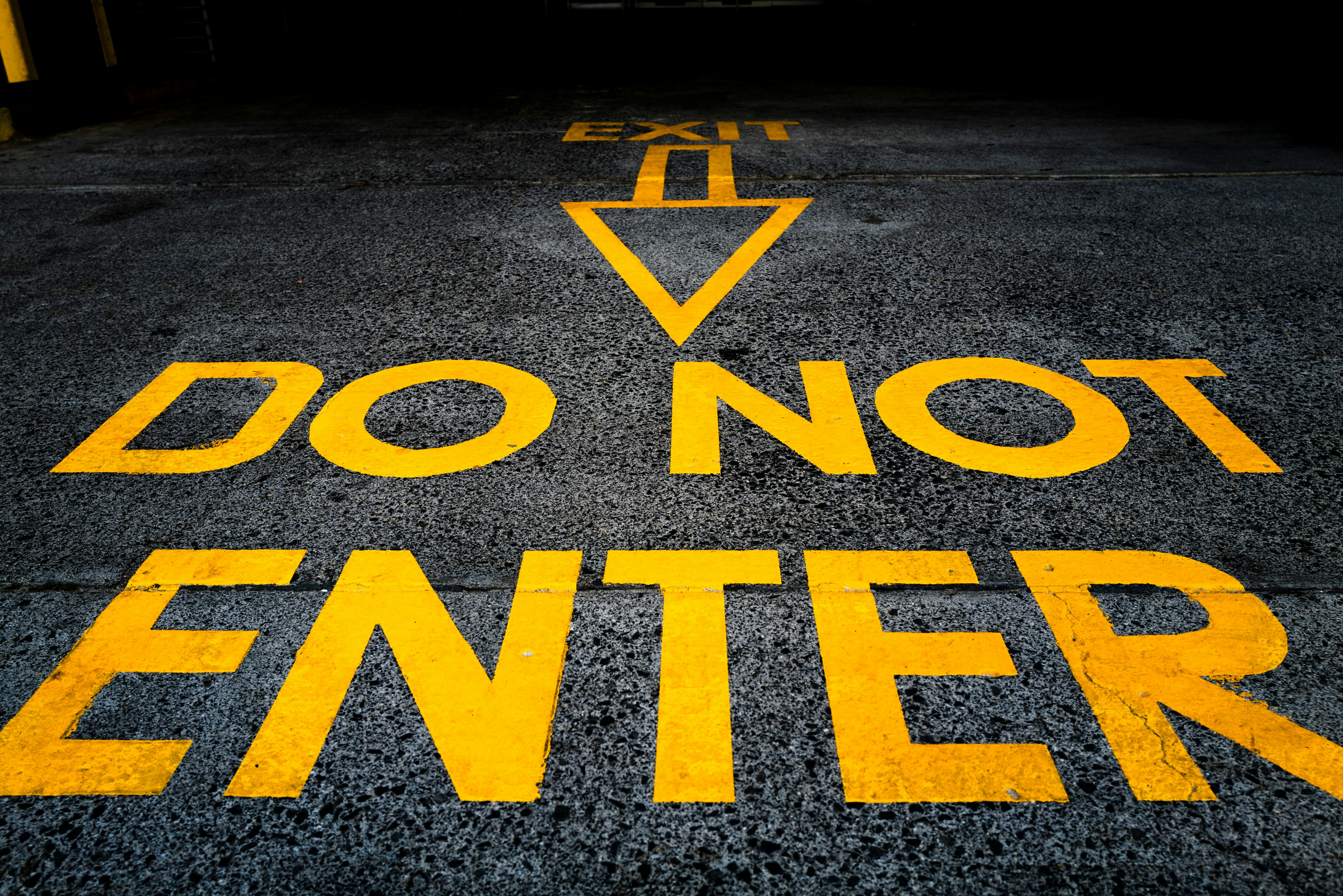 Yellow text reading 'DO NOT ENTER' painted on the ground