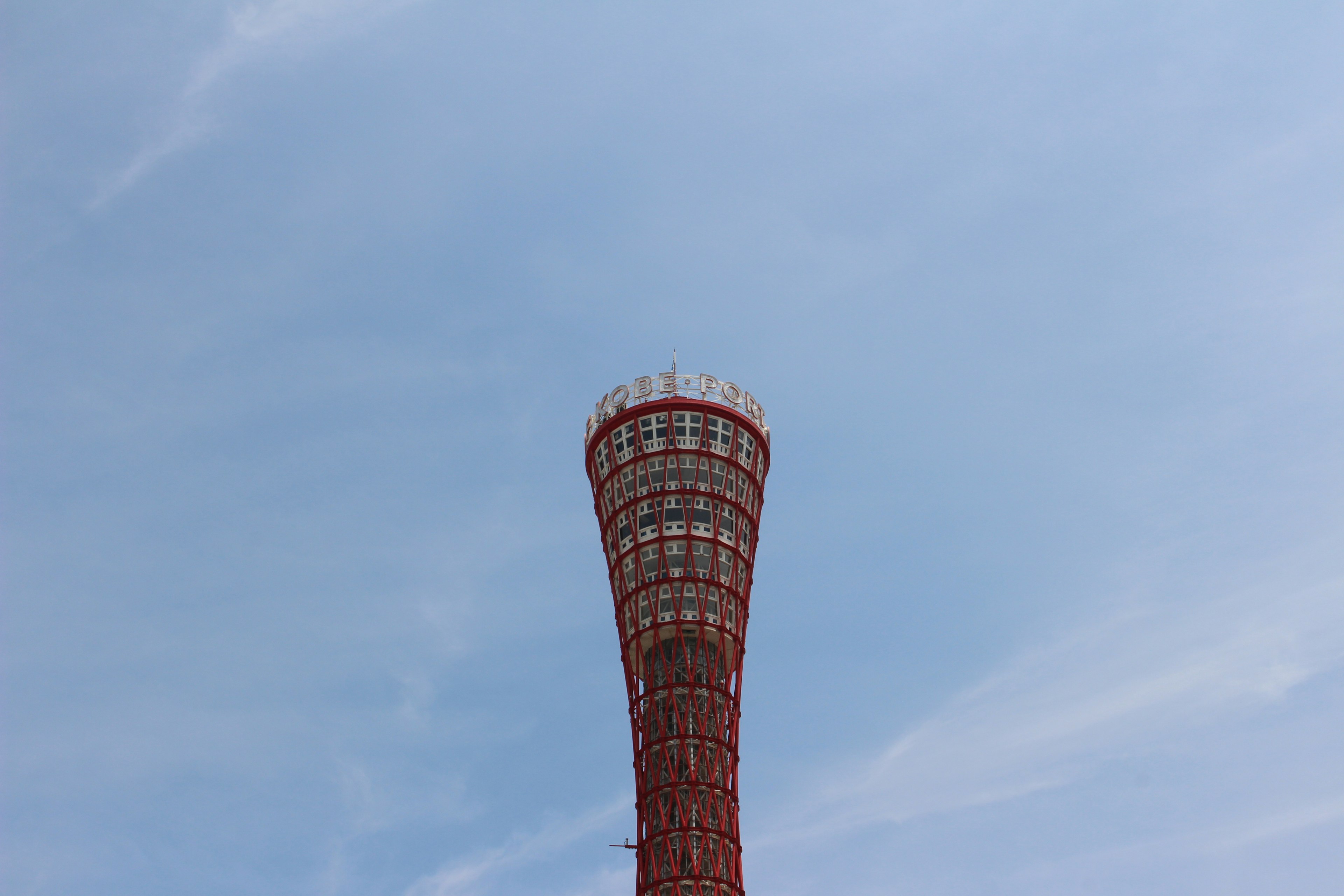 Kobe Port Tower mit roter Aussichtsplattform und blauem Himmel