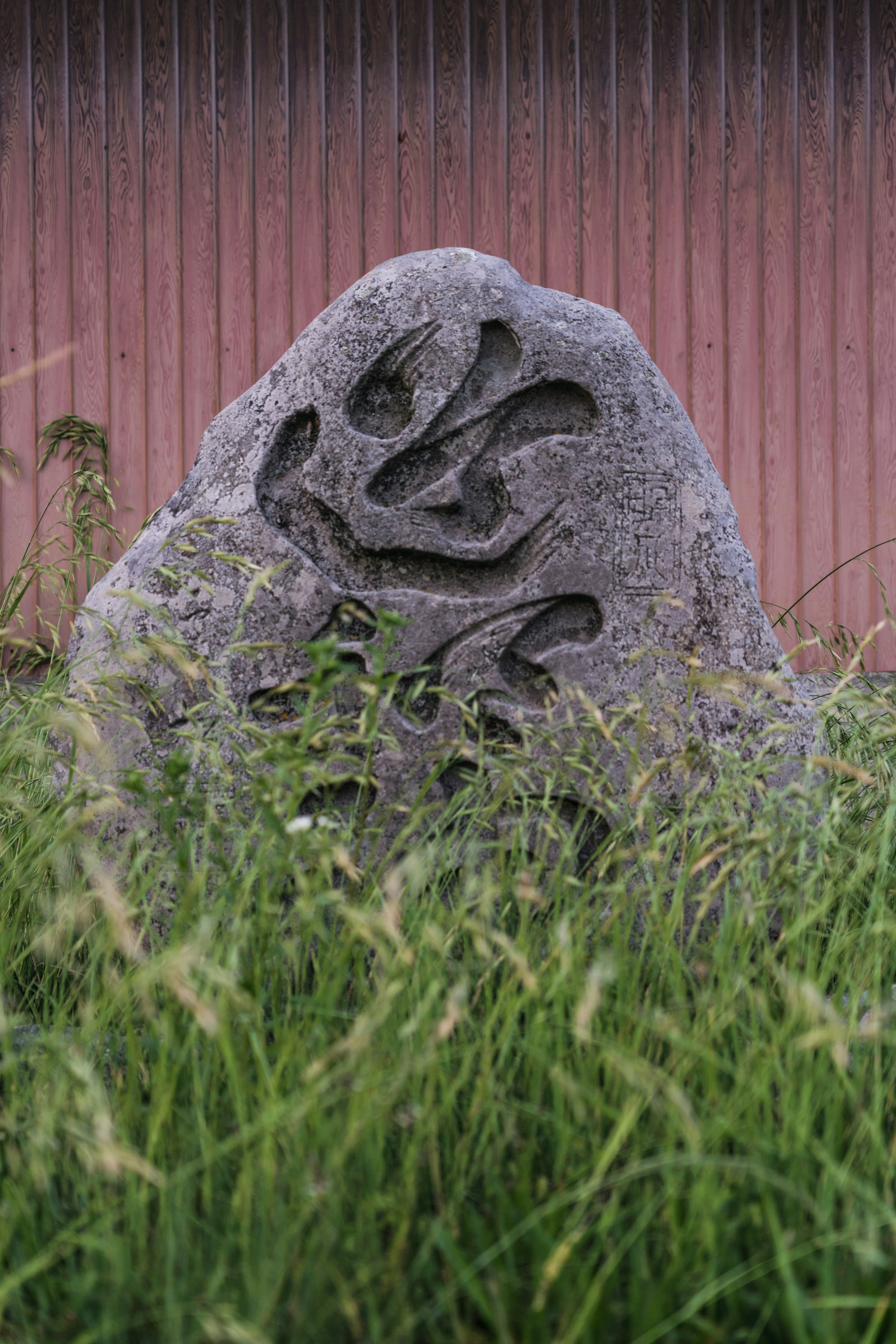 Sculpted stone monument surrounded by grass