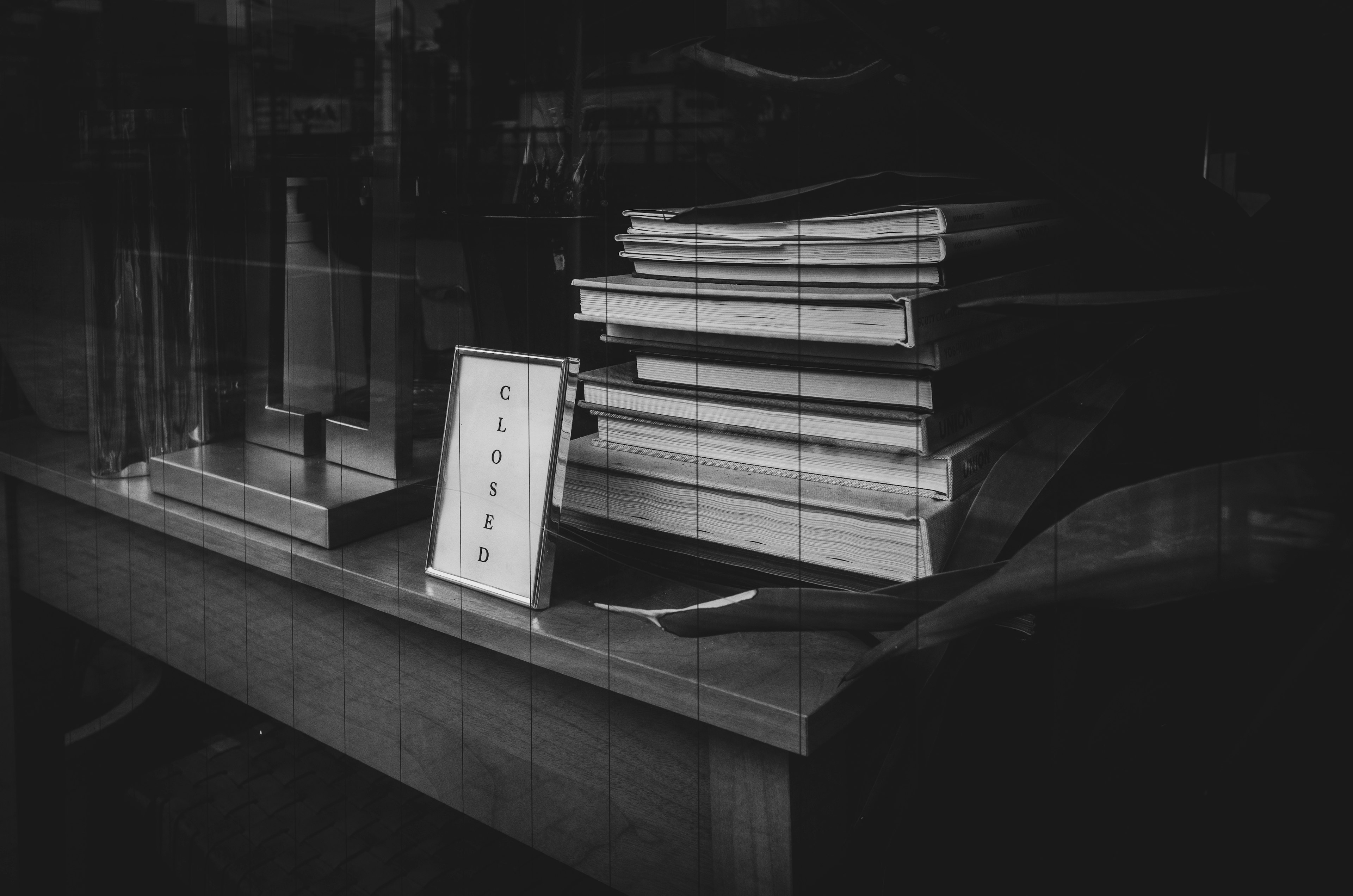 A stack of books and a framed picture in a quiet study setting