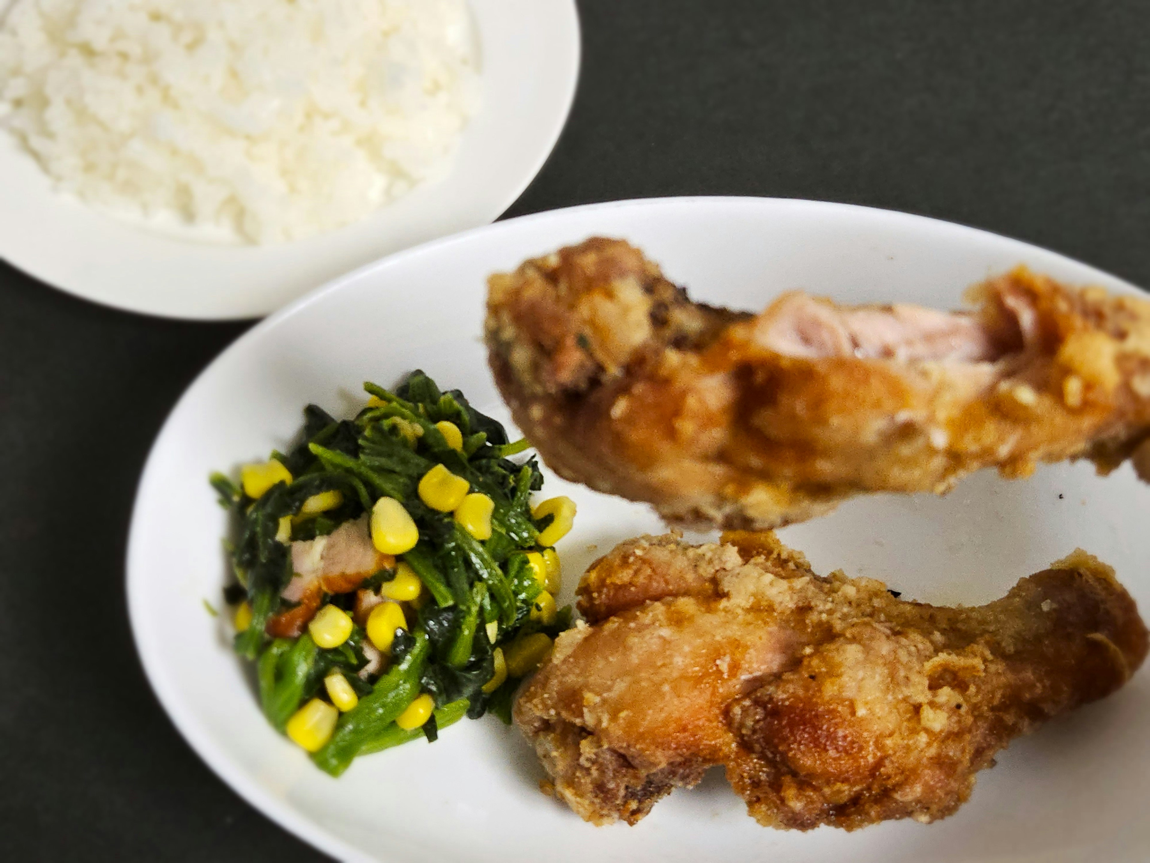 Plate of fried chicken with rice and vegetable salad