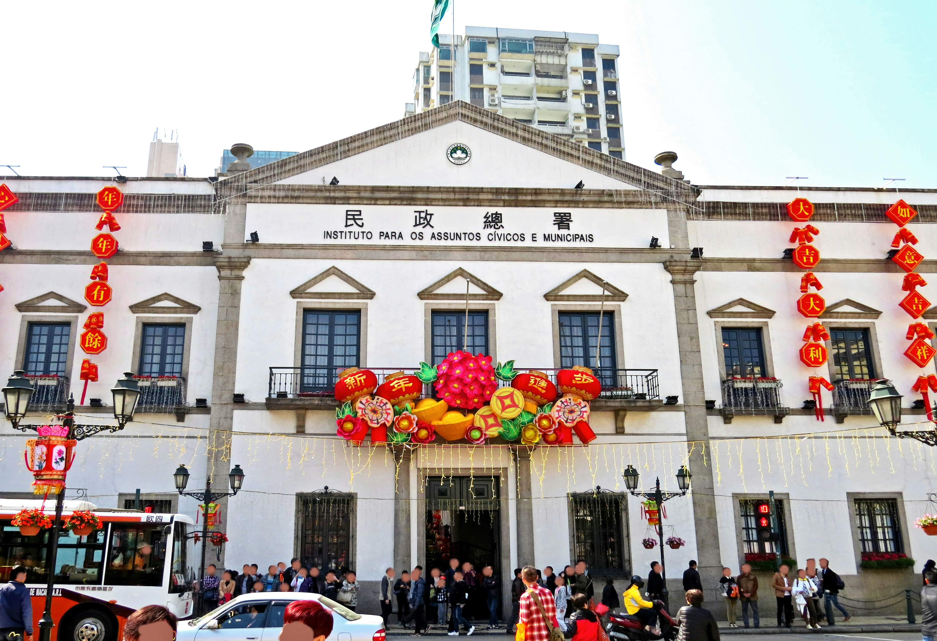 Traditional building adorned with colorful lanterns many people gathered outside