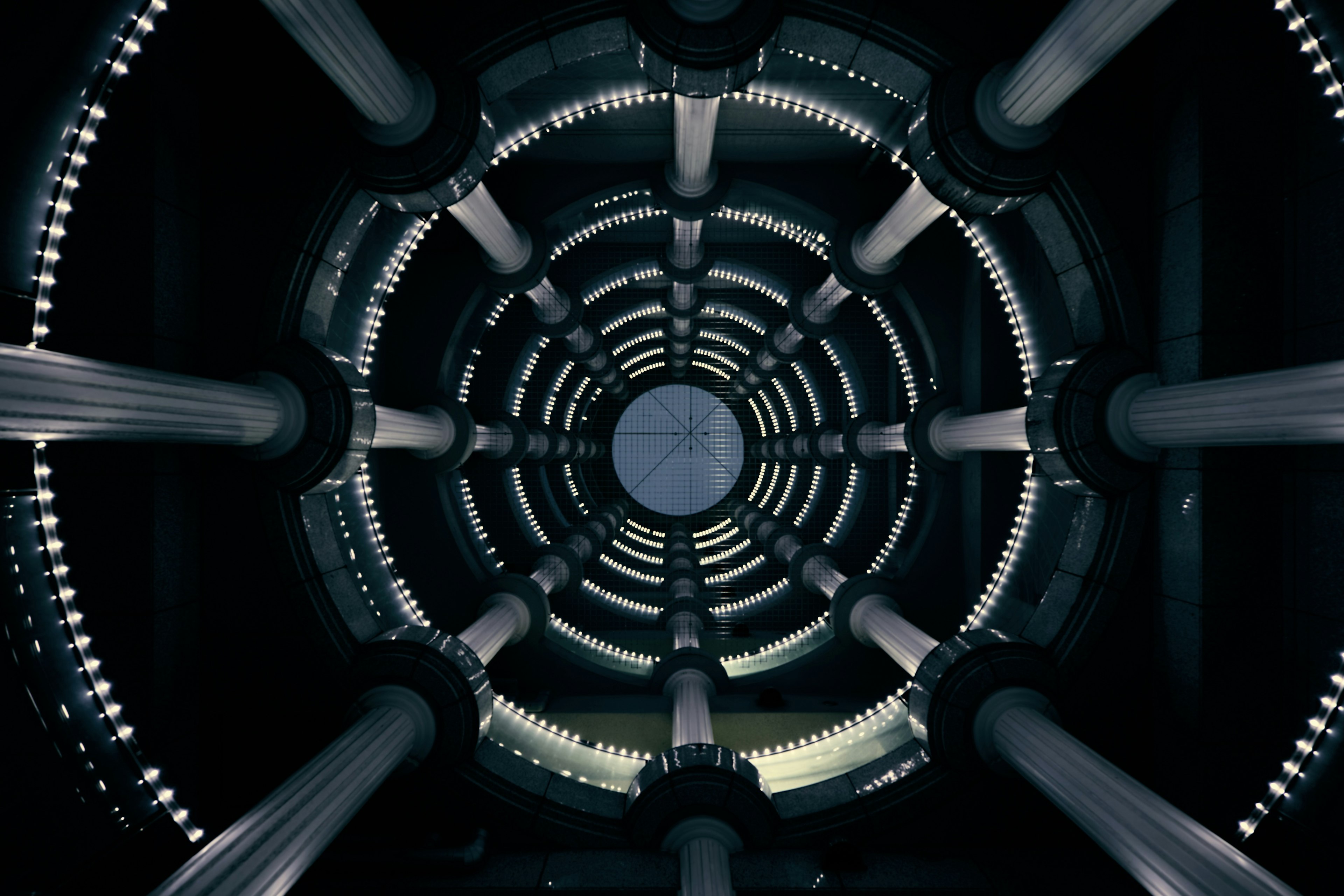 Photo of a circular ceiling featuring columns and a unique light design