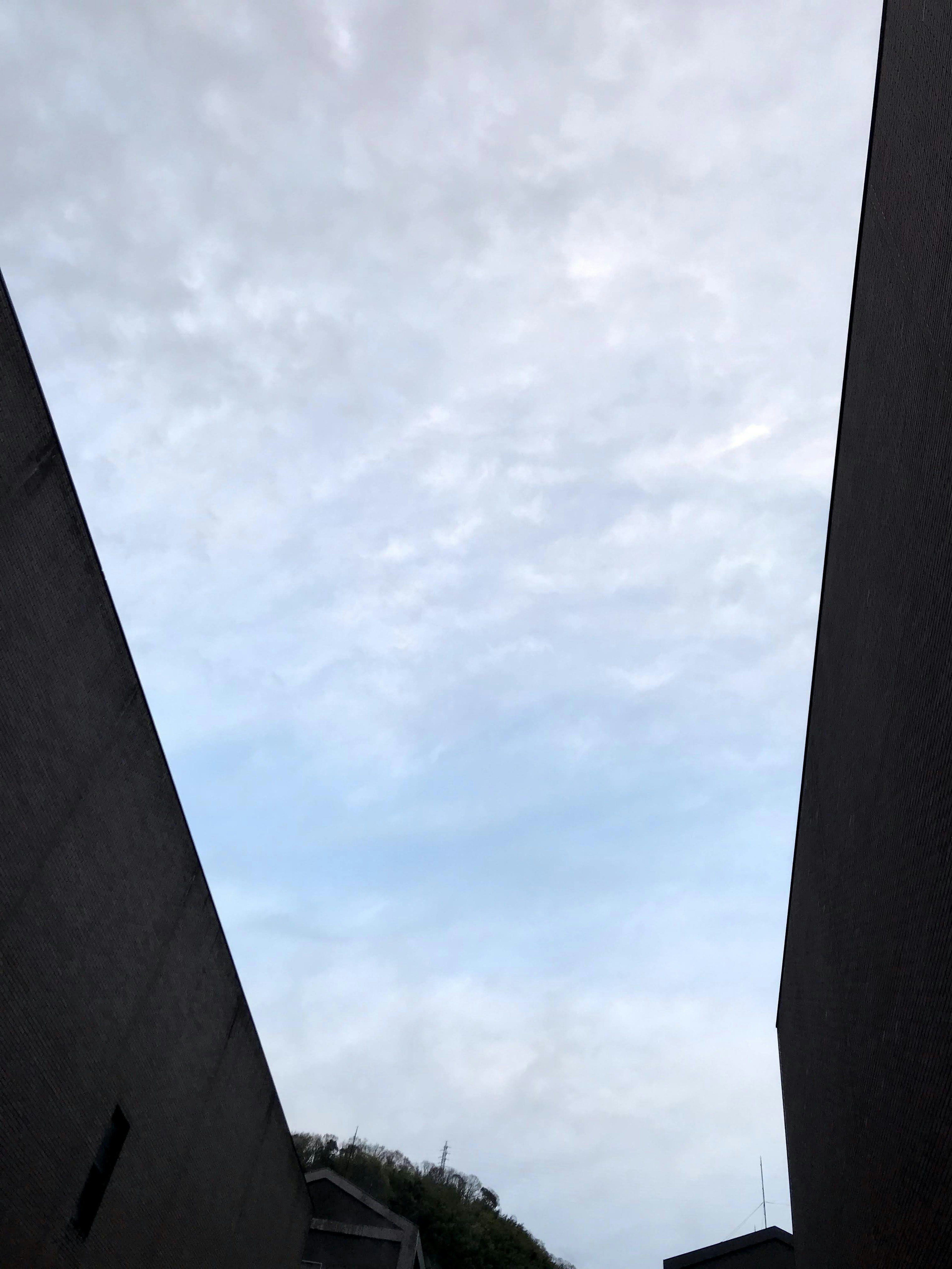 View of cloudy sky between two buildings