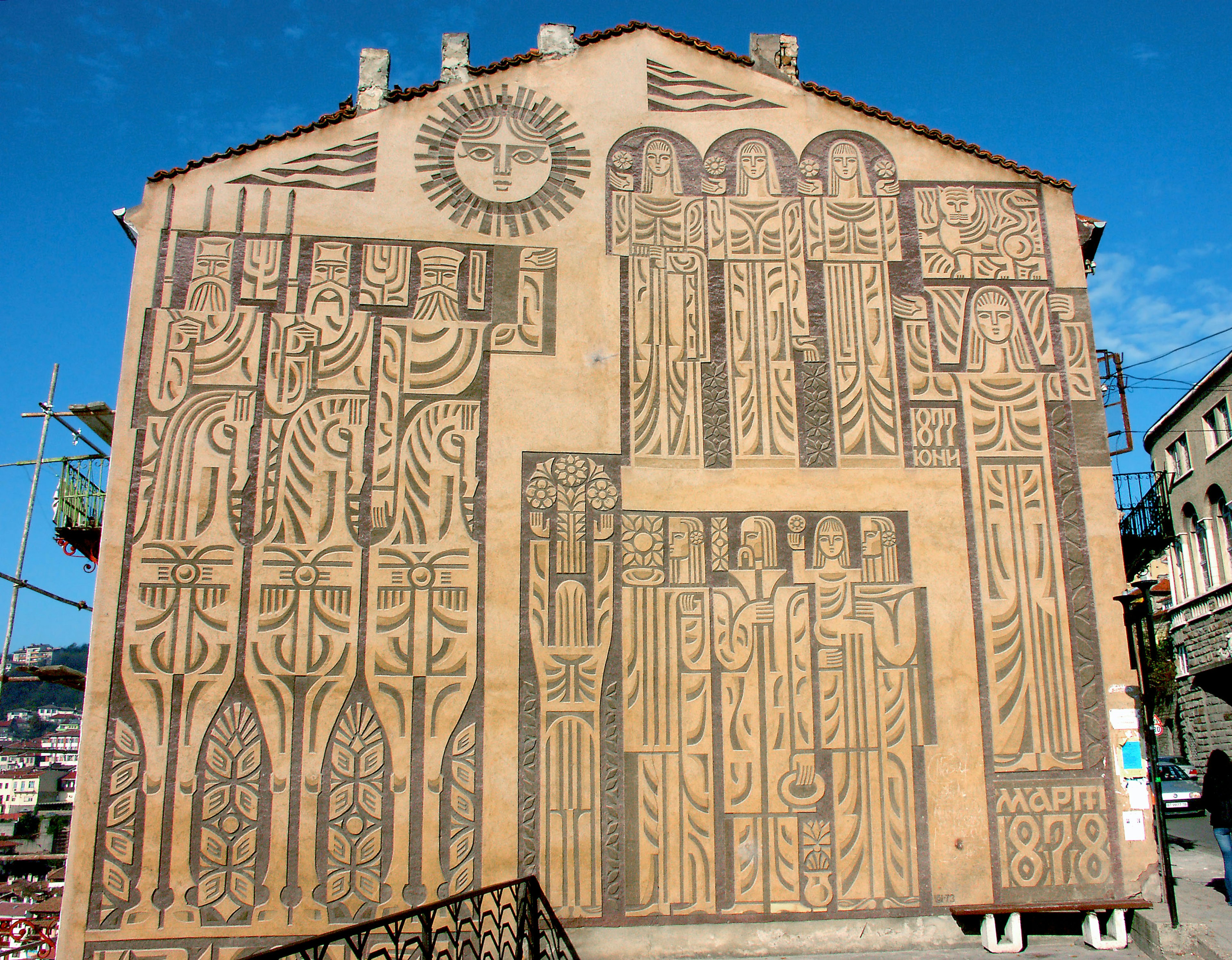 Exterior of a building featuring large sculptural wall art with intricate designs