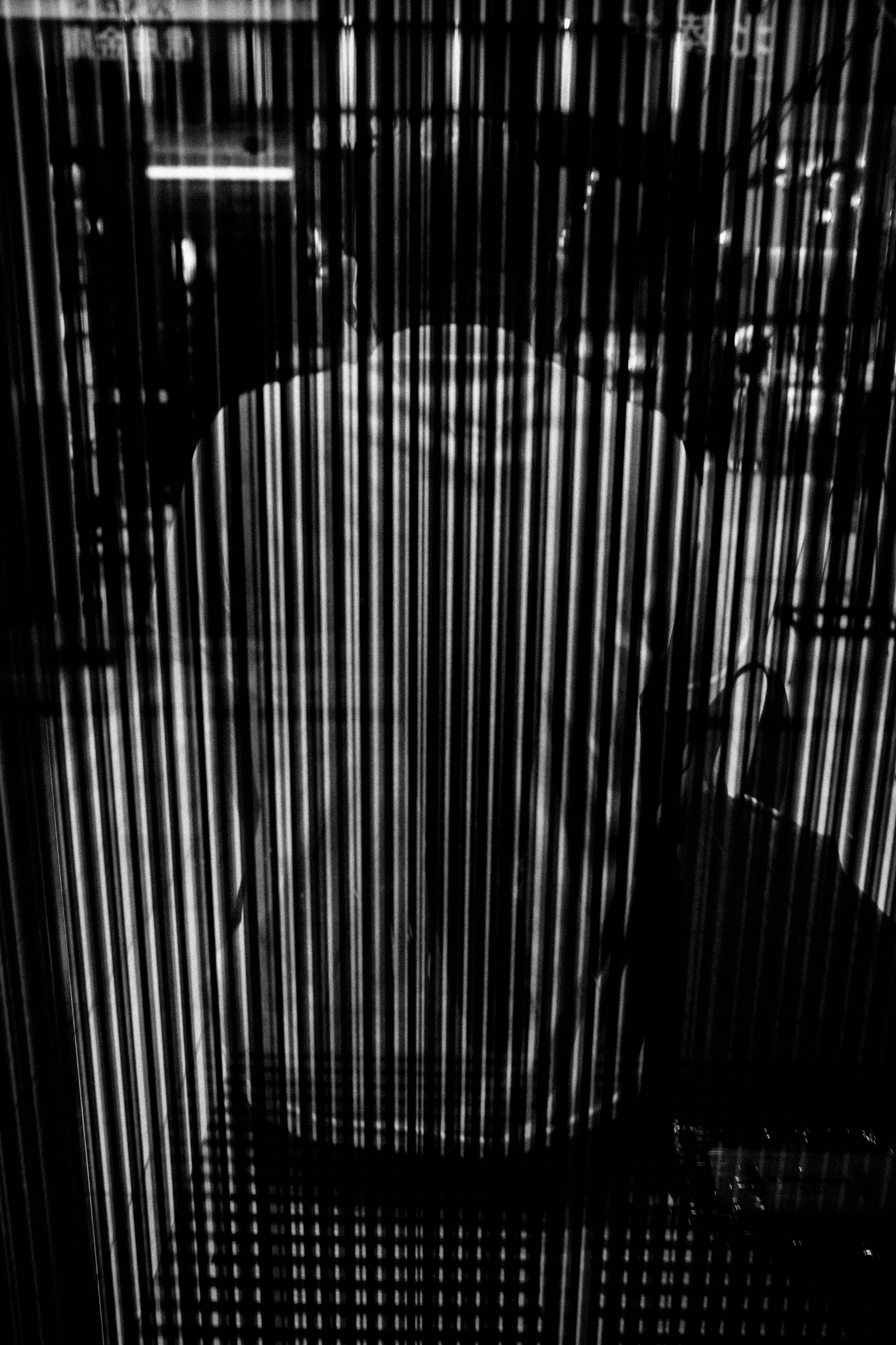 Silhouette of a person with striped shadows on a black background