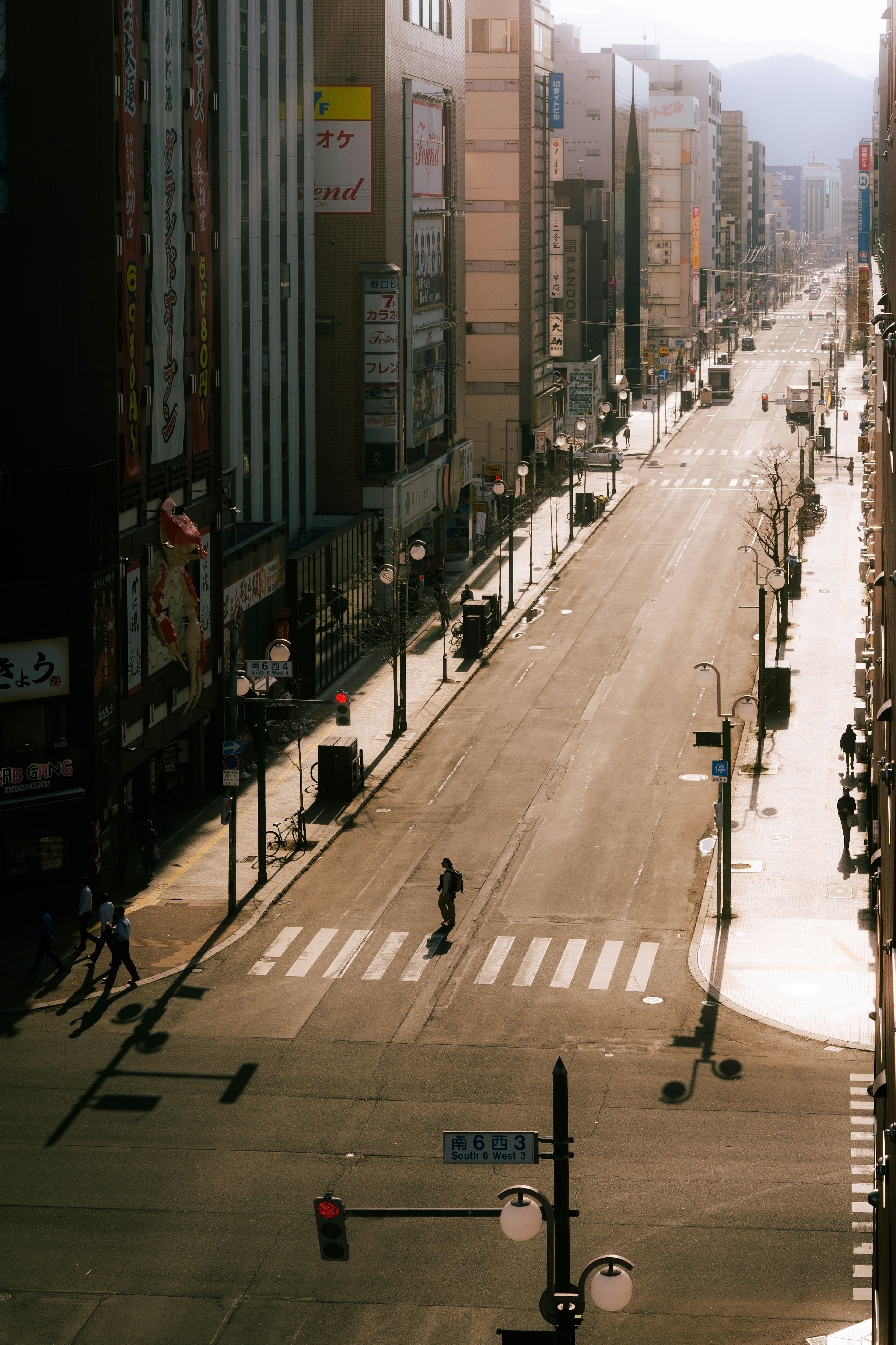 An empty street with a single person walking