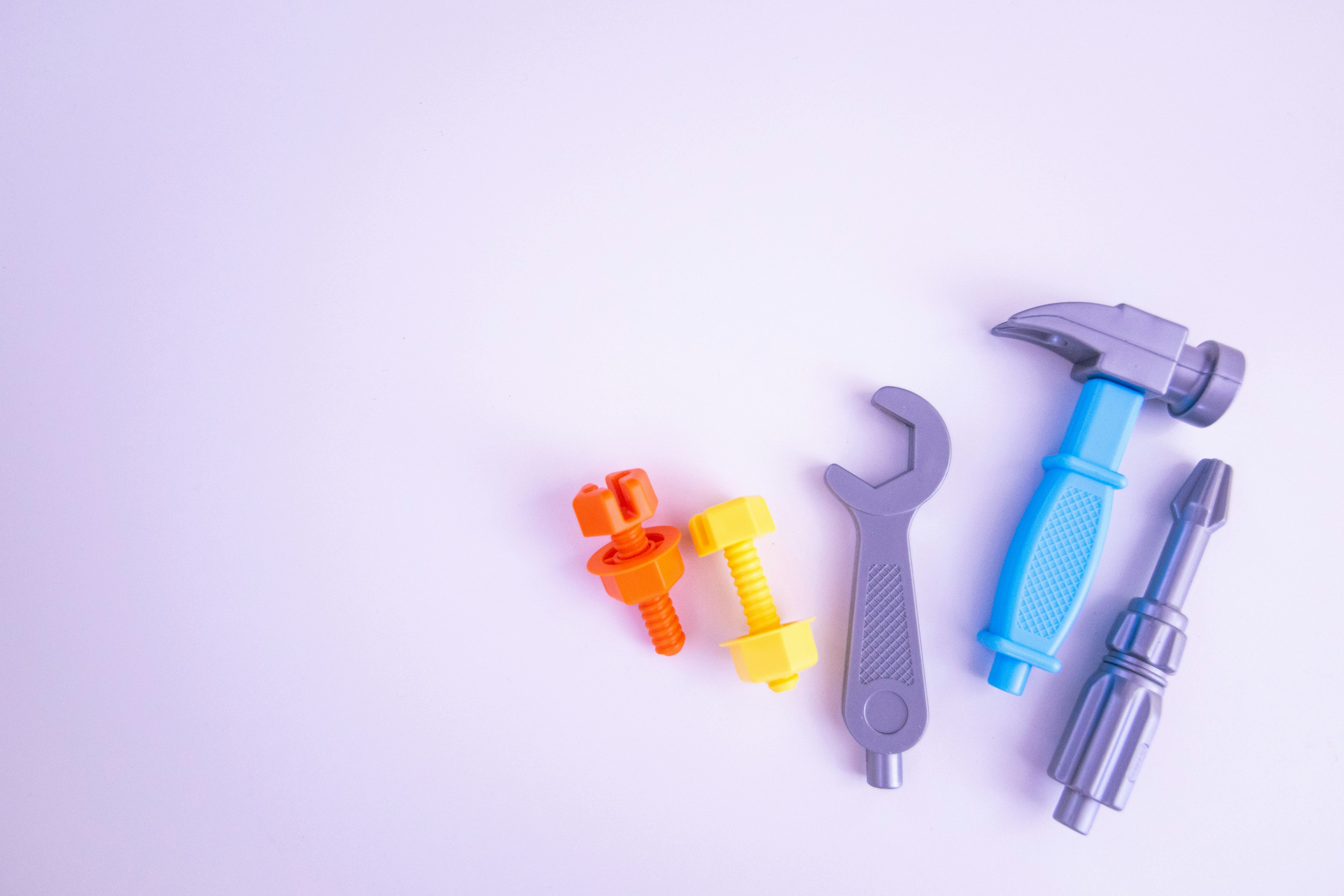 Colorful plastic tool set arranged on a white background