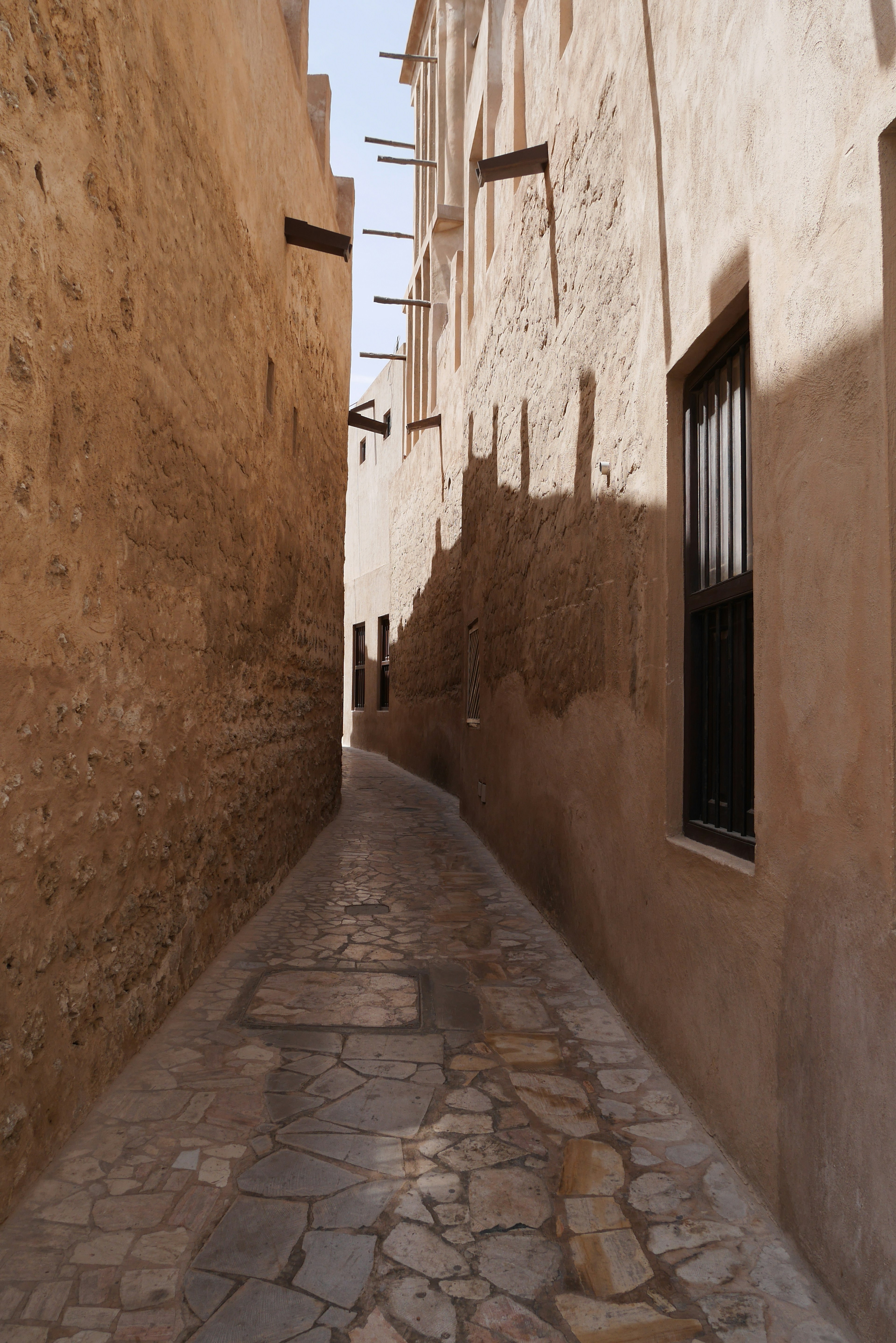 Narrow cobblestone alleyway between old buildings