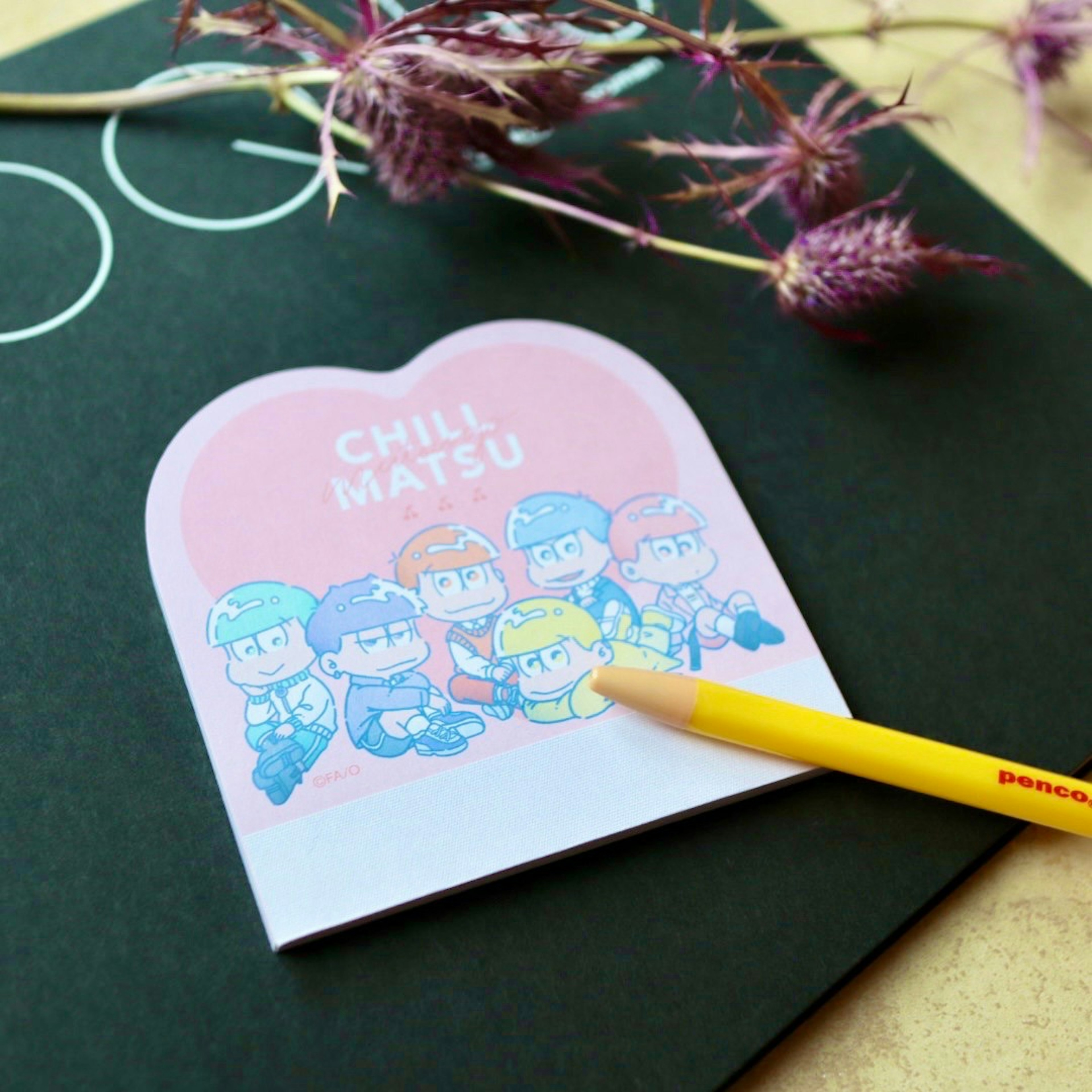 Heart-shaped sticky note featuring colorful characters with a yellow pencil