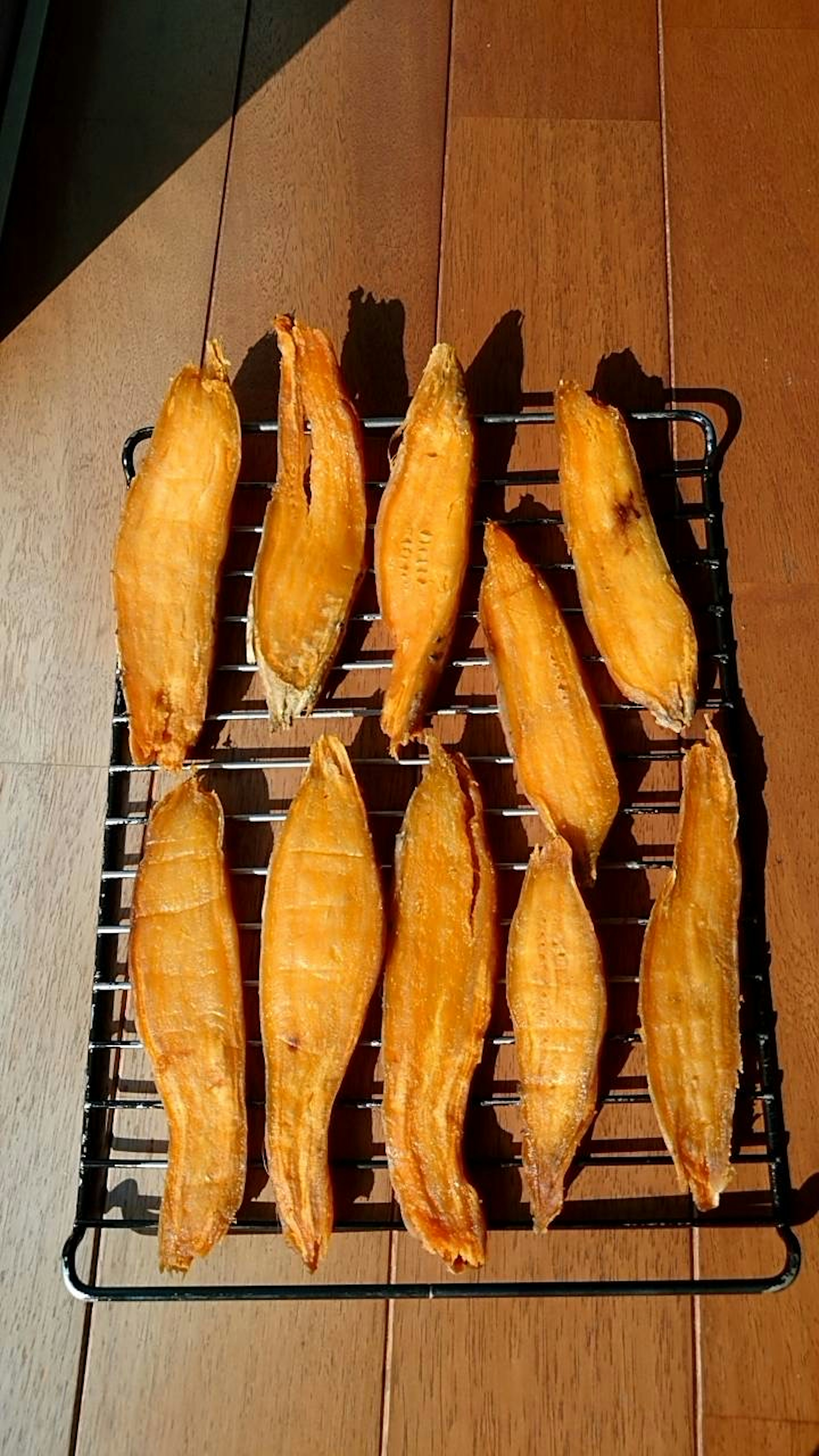 Grilled fish arranged on a wire rack