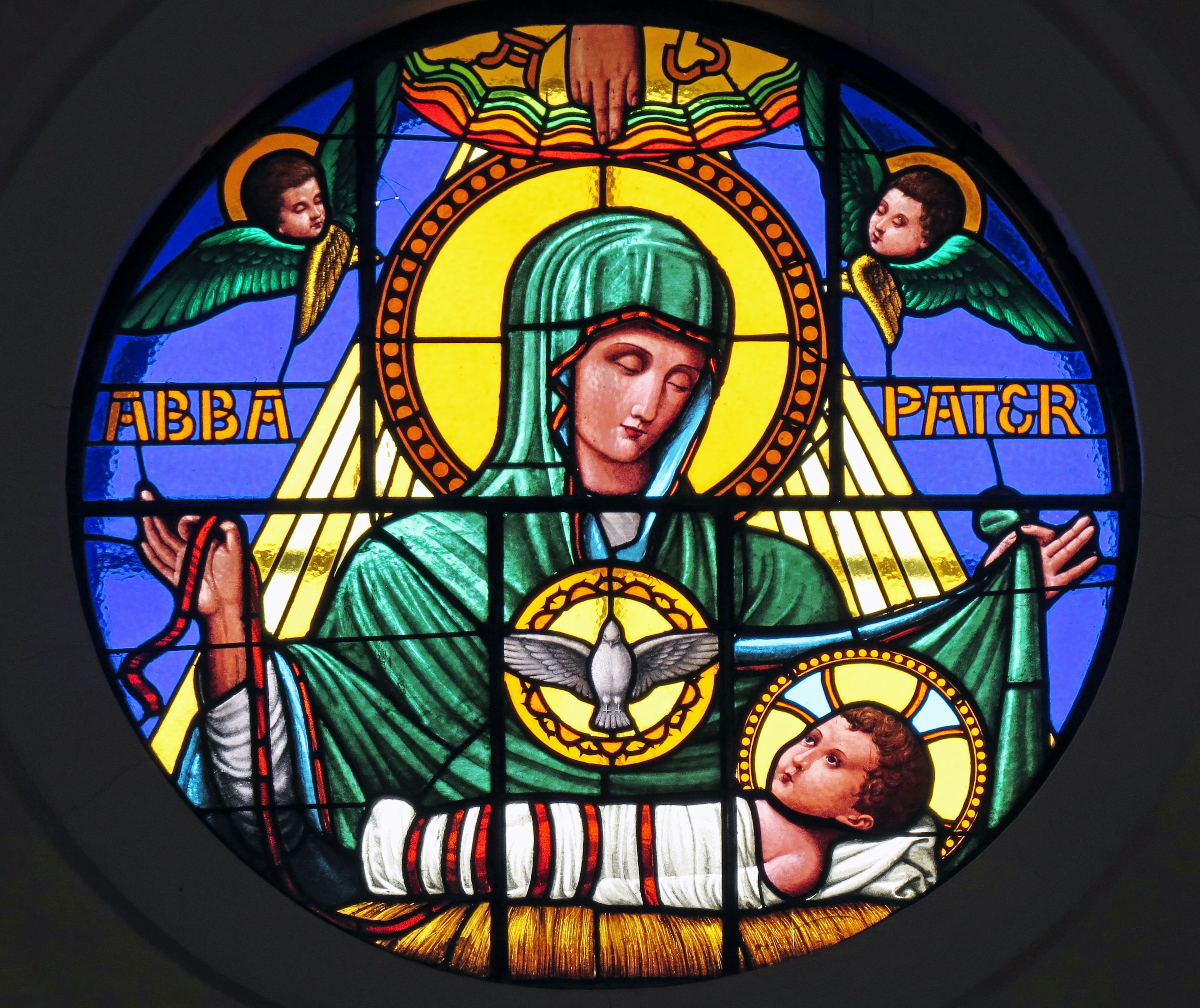 Stained glass window depicting Virgin Mary holding the infant Jesus