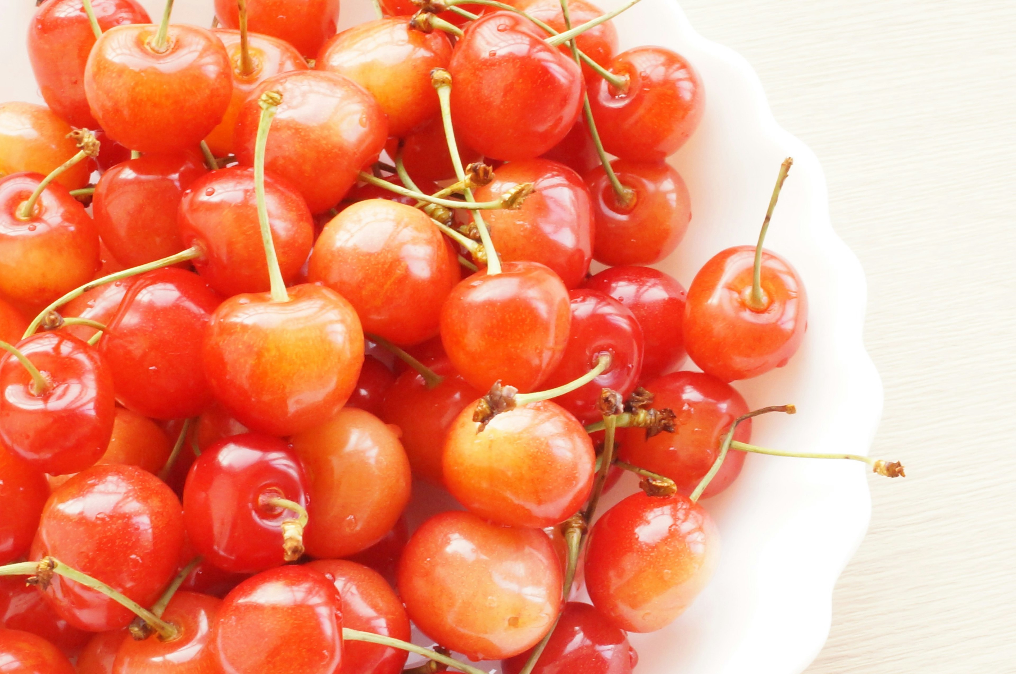 A plate filled with bright red cherries