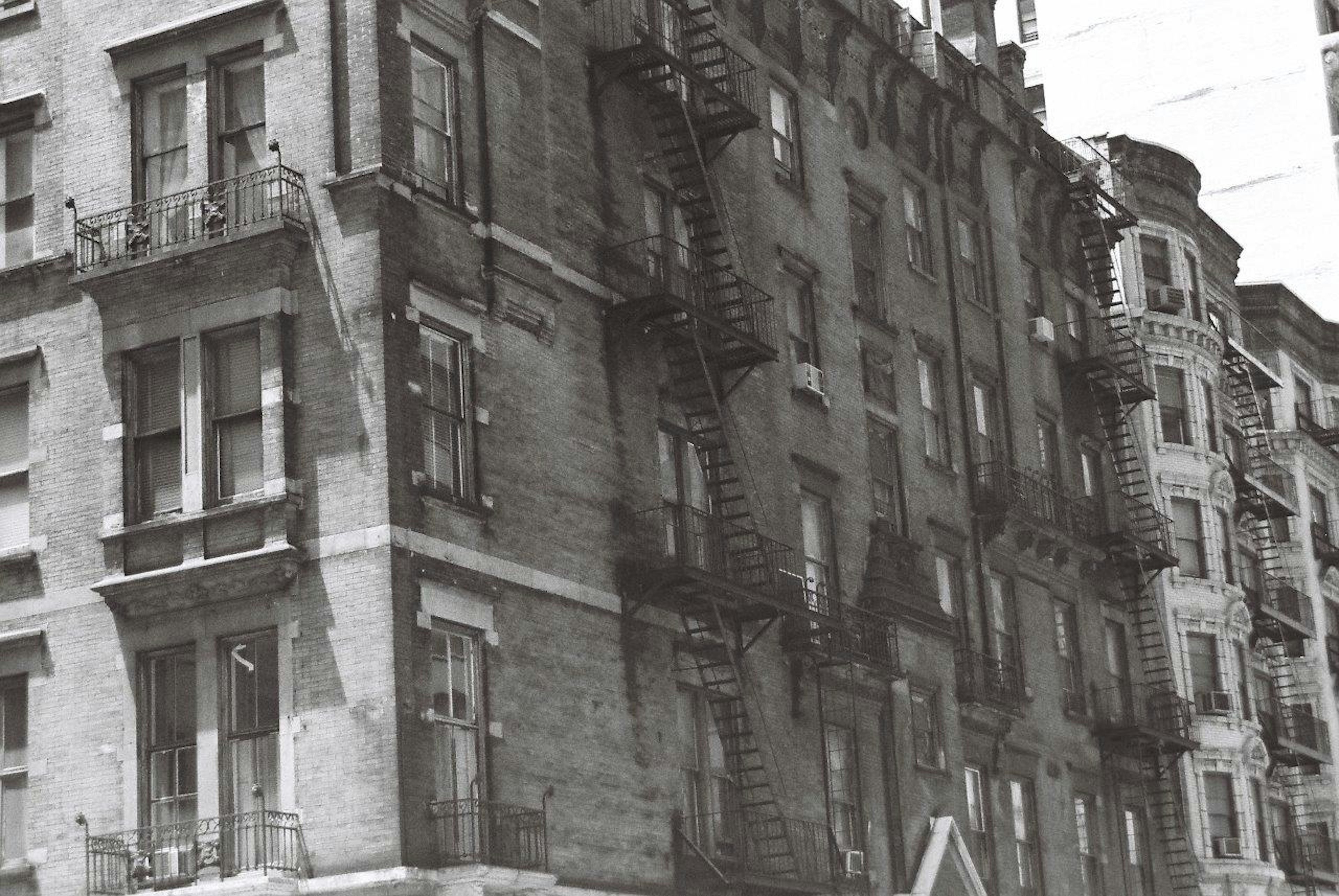 Facade of an old apartment building with metal fire escapes