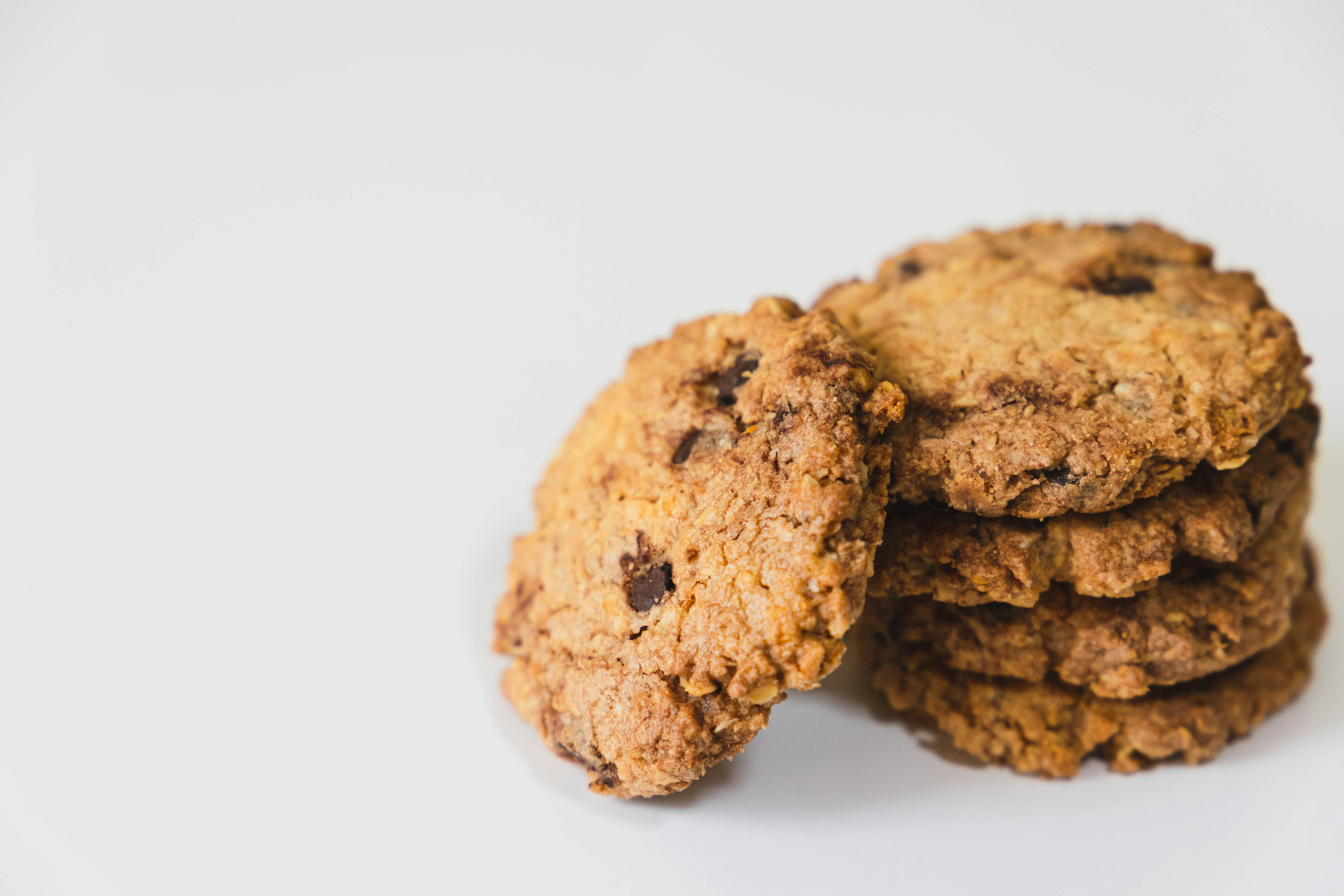 A stack of chocolate chip cookies on a white background