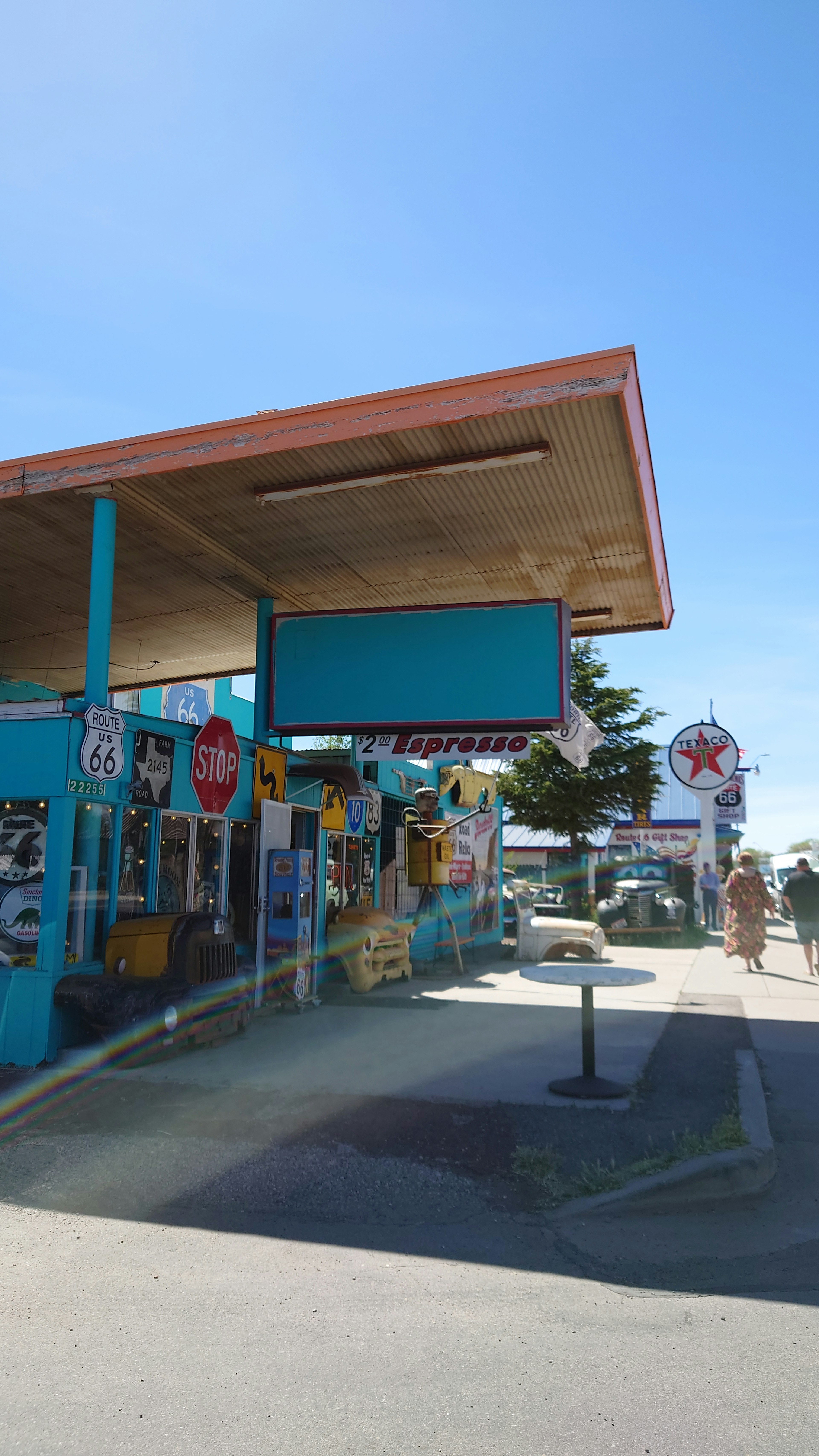 View of a colorful storefront with blue walls and various signs