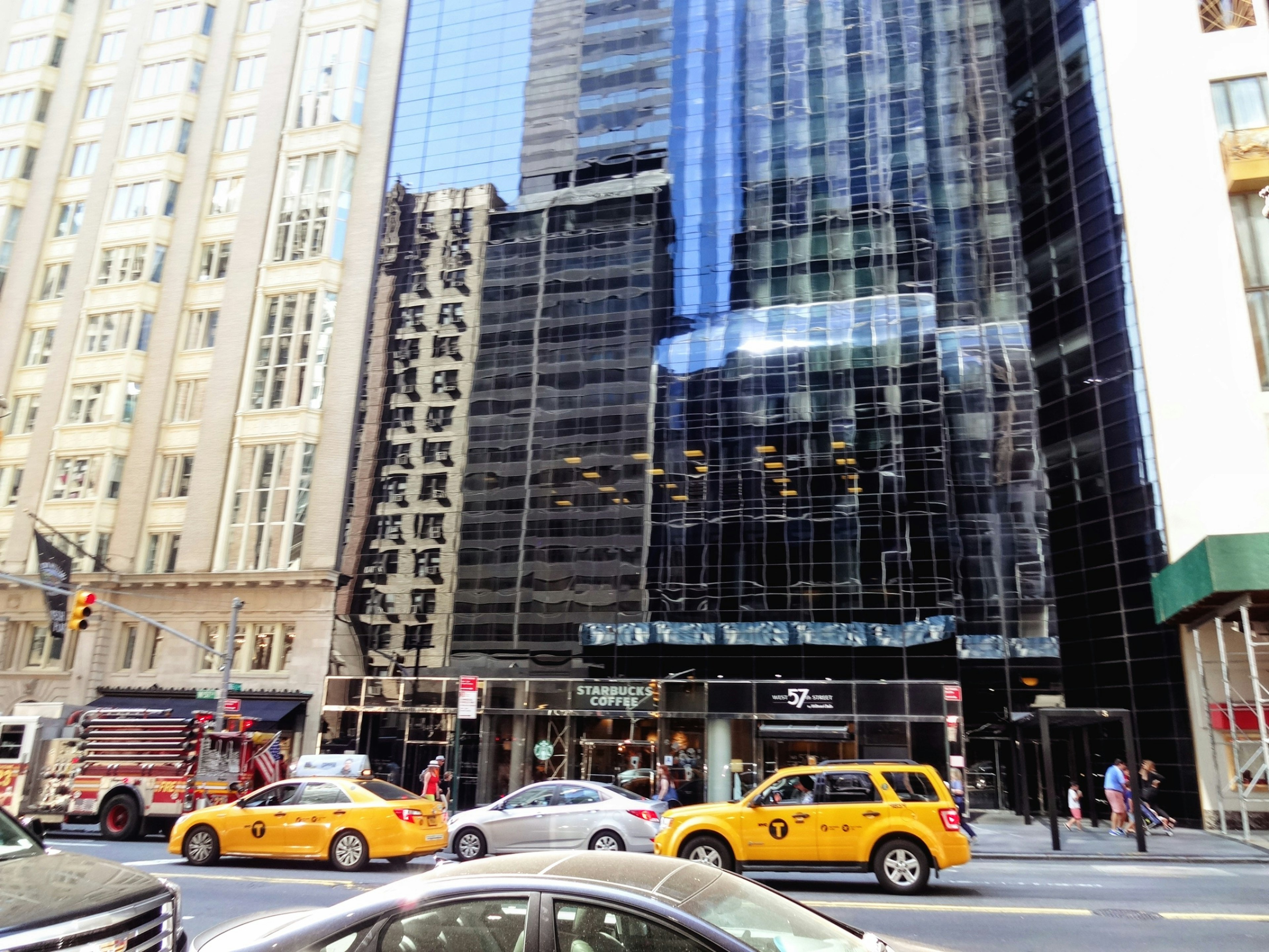 Urban scene with skyscrapers and yellow taxis in traffic