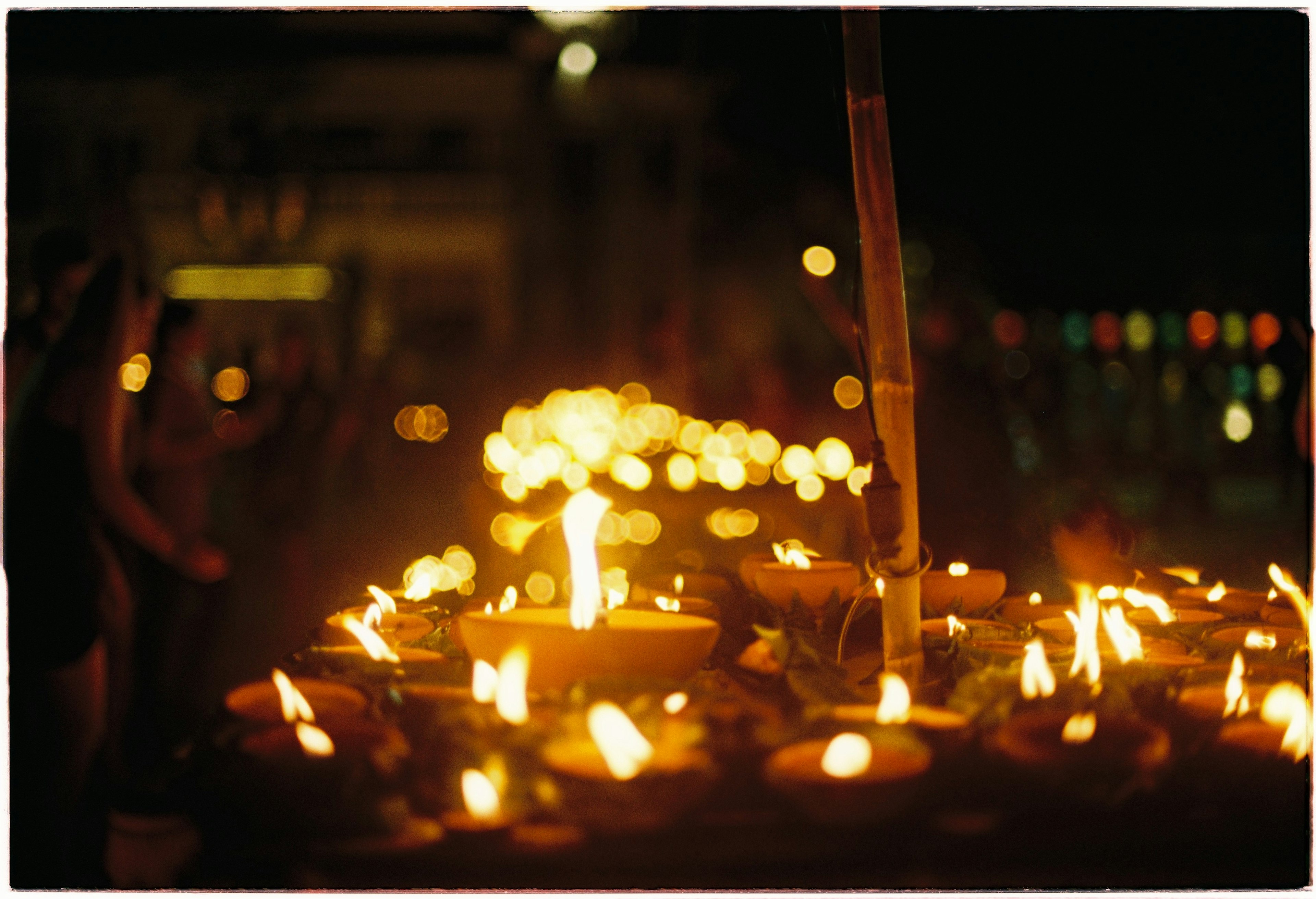 A scene of numerous candles lit during a night festival