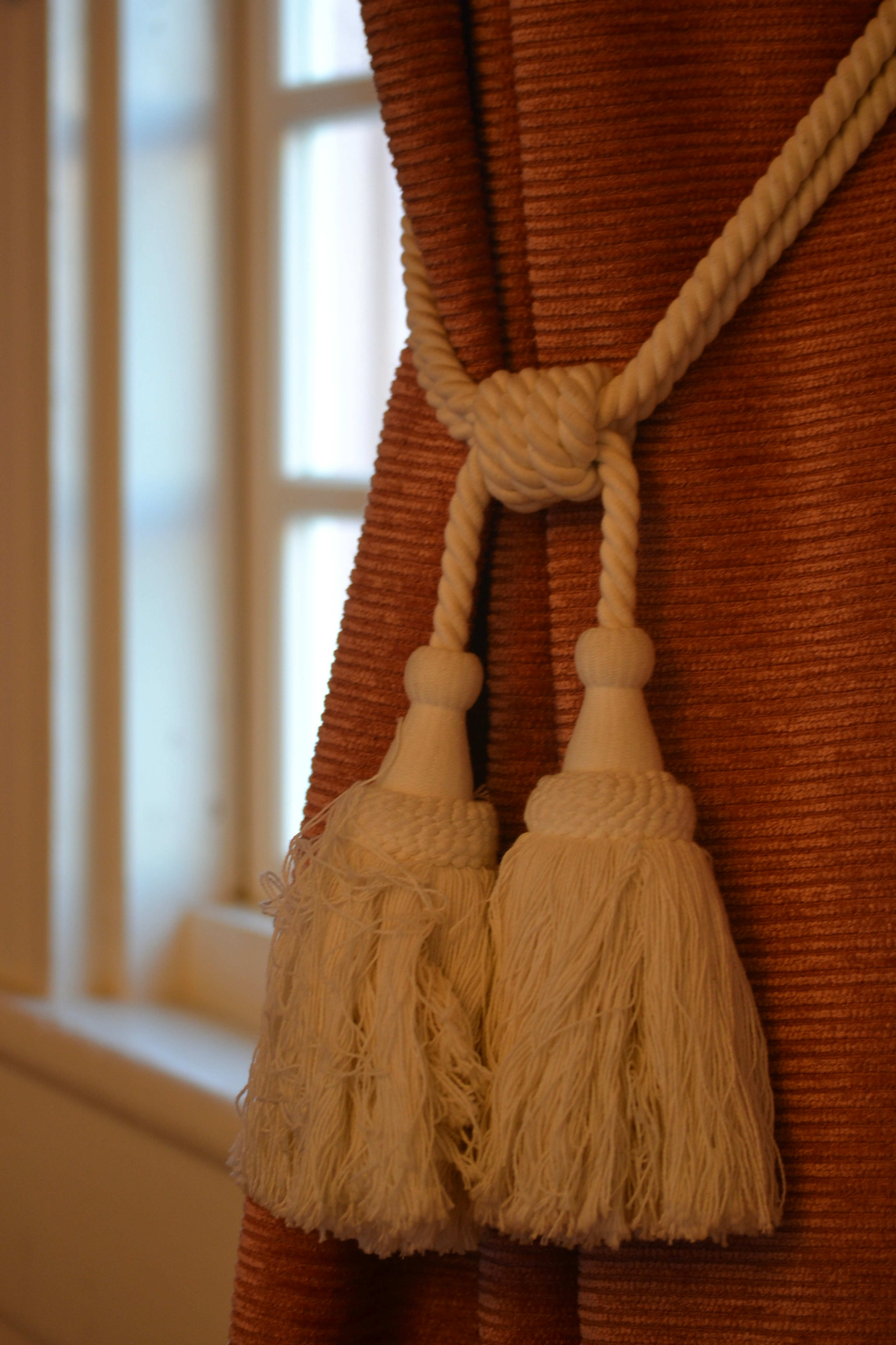 Tassels de cortina atados elegantemente con cuerda blanca