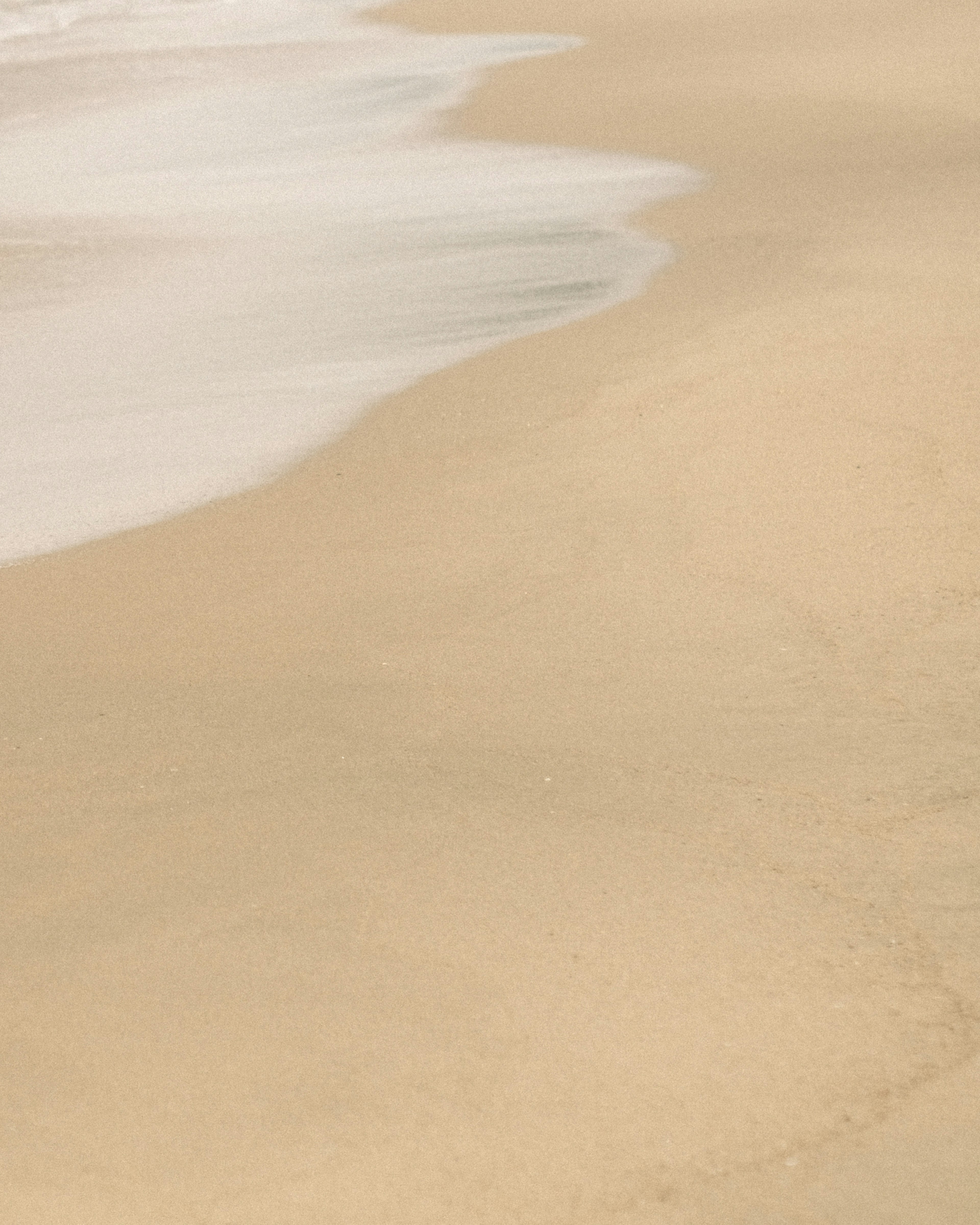 Calm waves lapping at a sandy beach