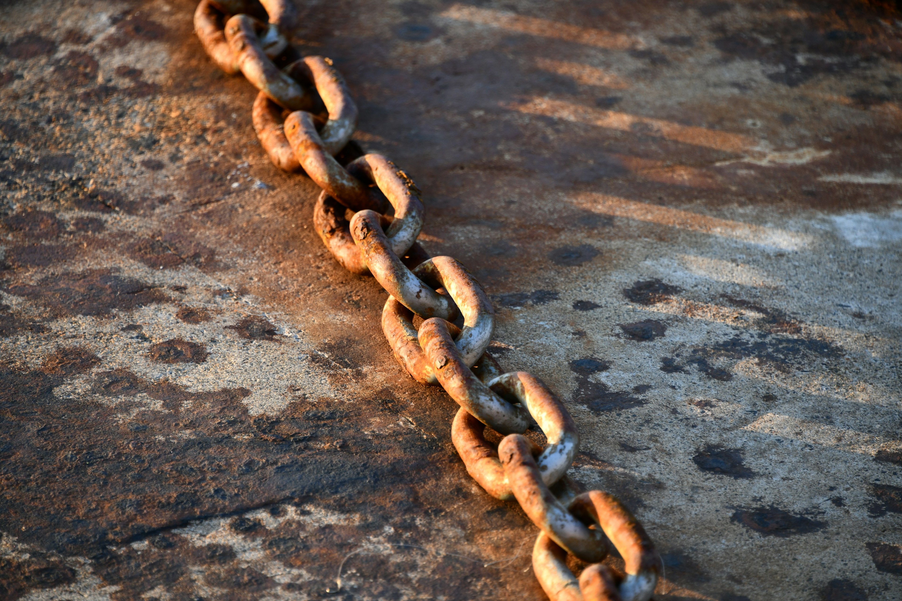 rusted chain on weathered surface