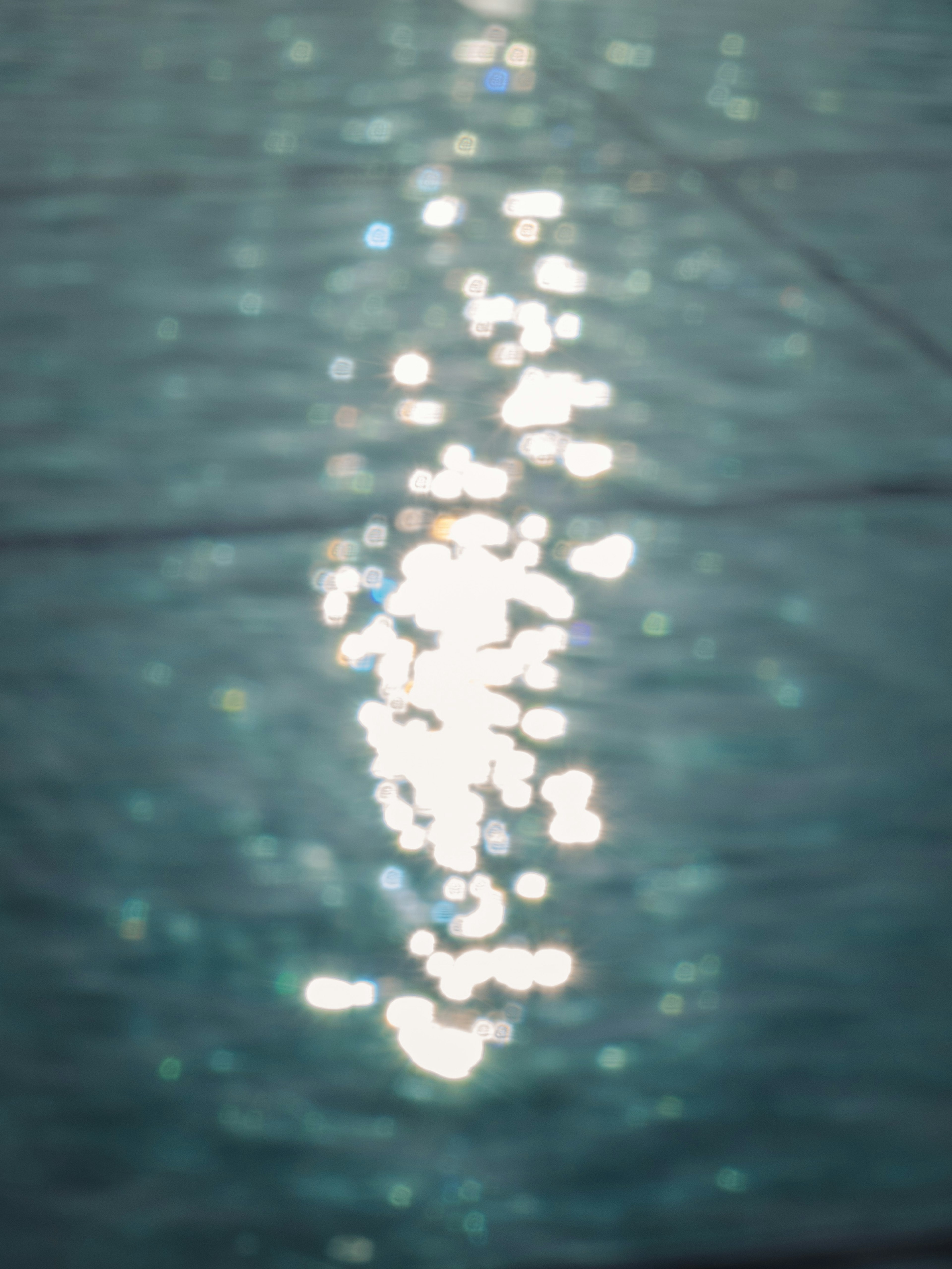 Blurred surface of water with reflections of light