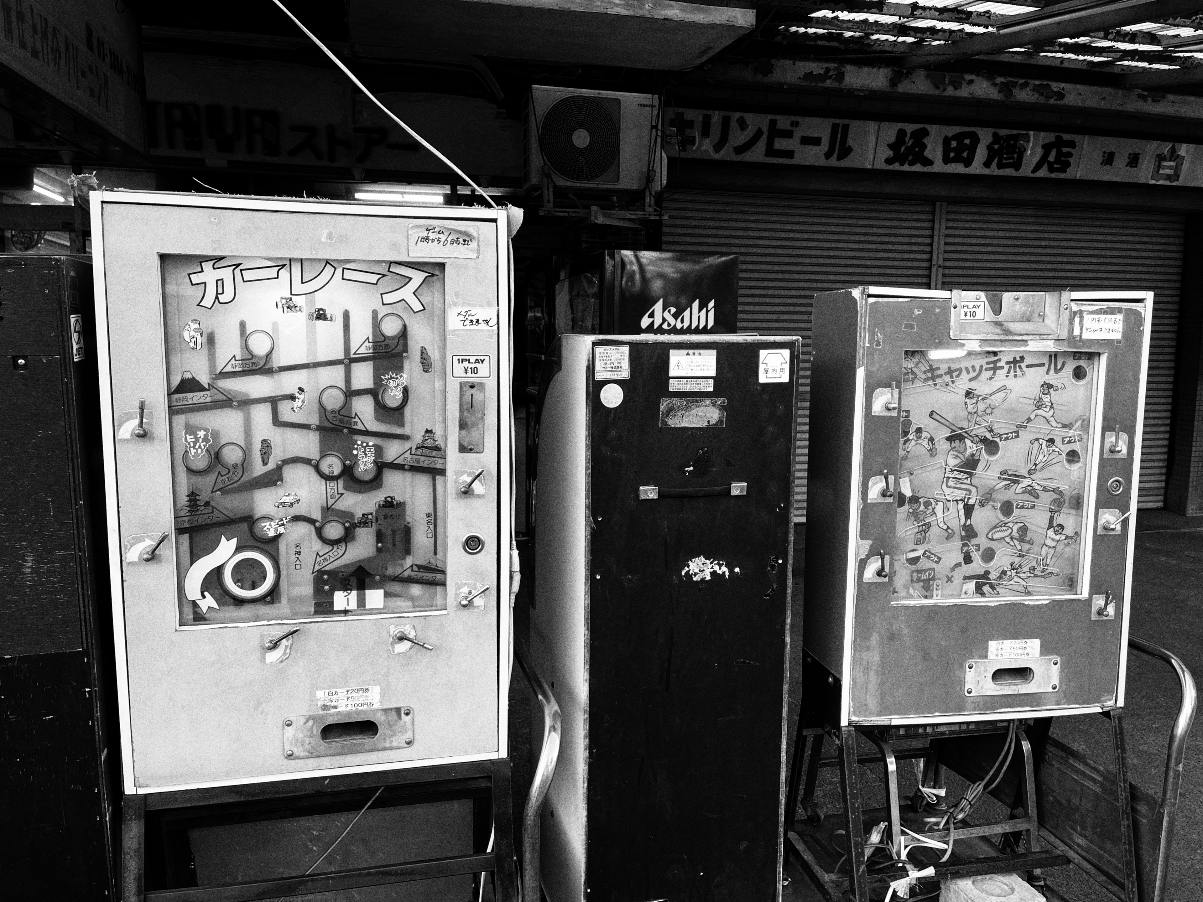 Old vending machines lined up in a black and white photo vintage atmosphere