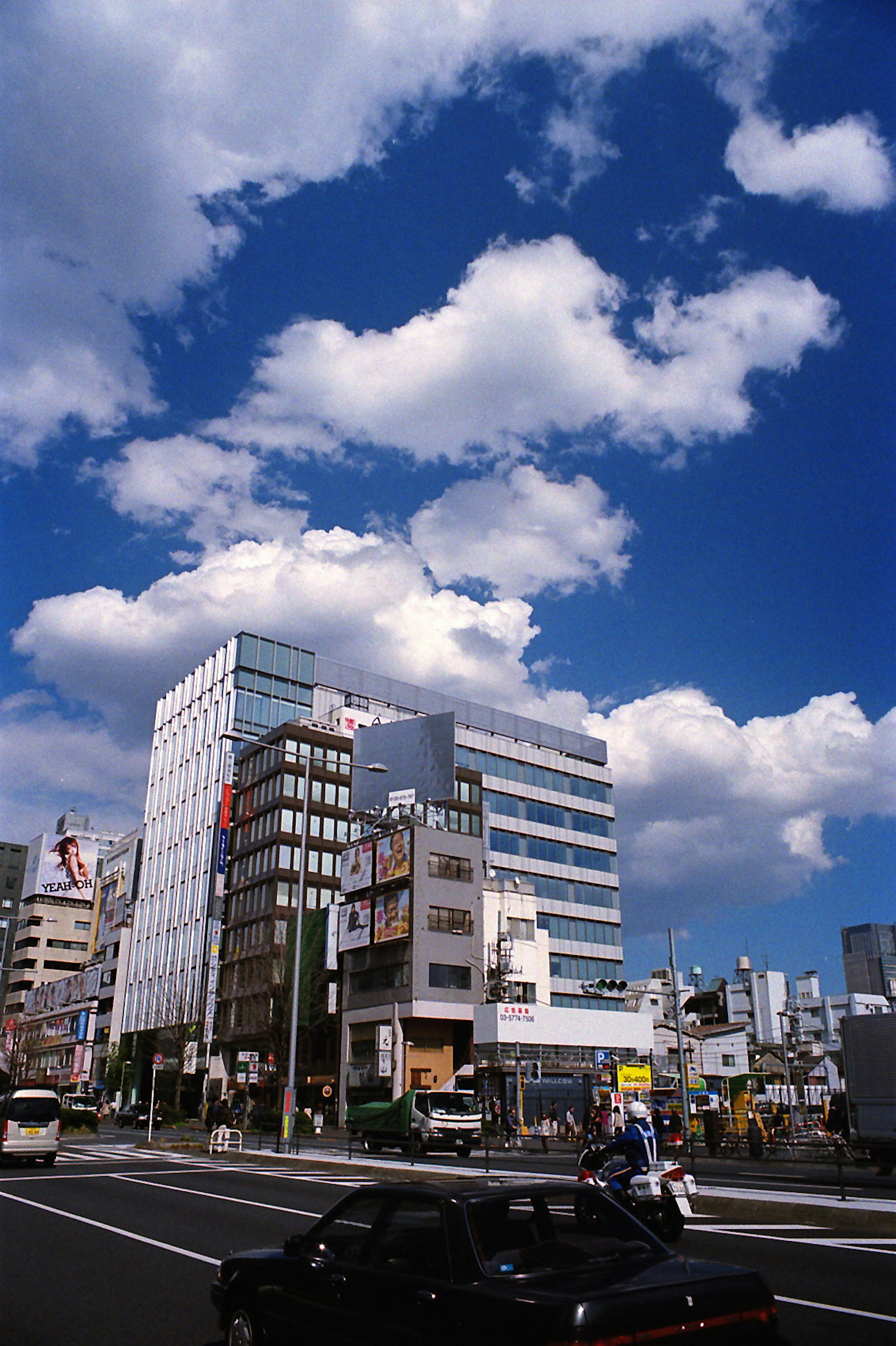 Urban landscape with tall buildings under a bright blue sky