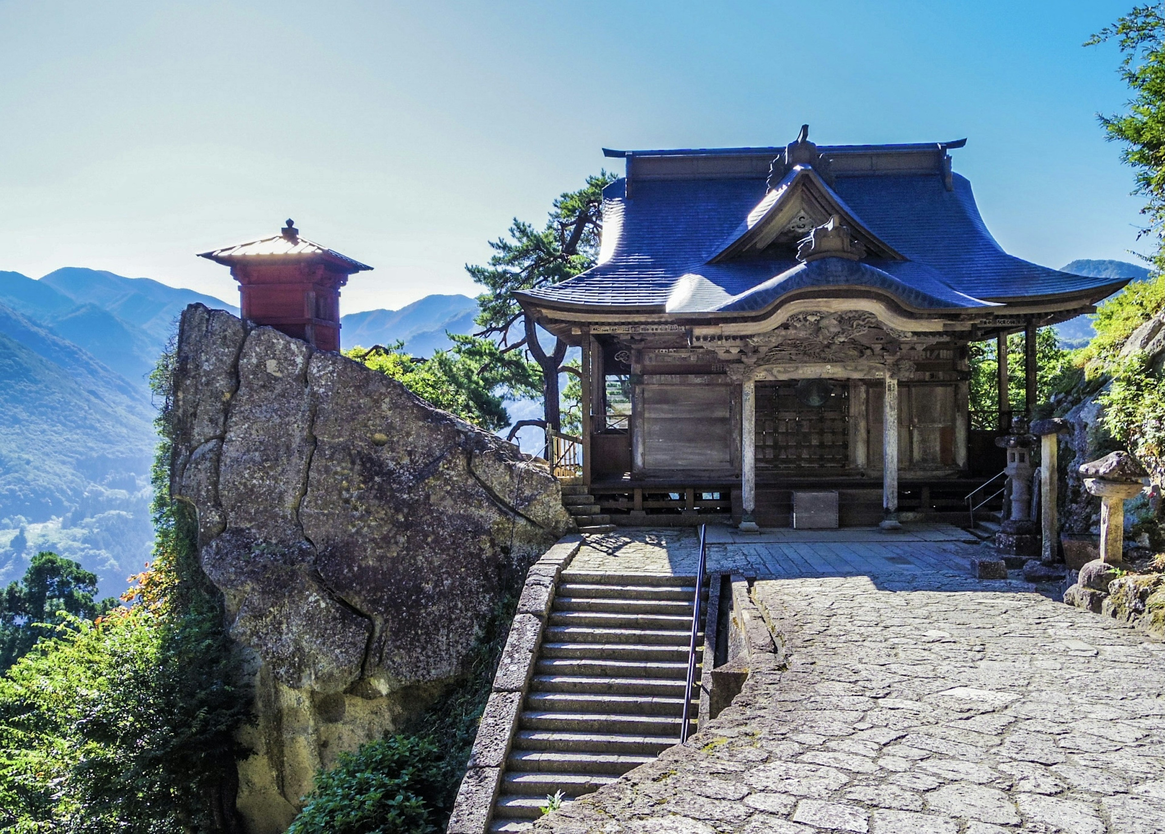 Traditional Japanese temple with stone steps in a beautiful mountain landscape