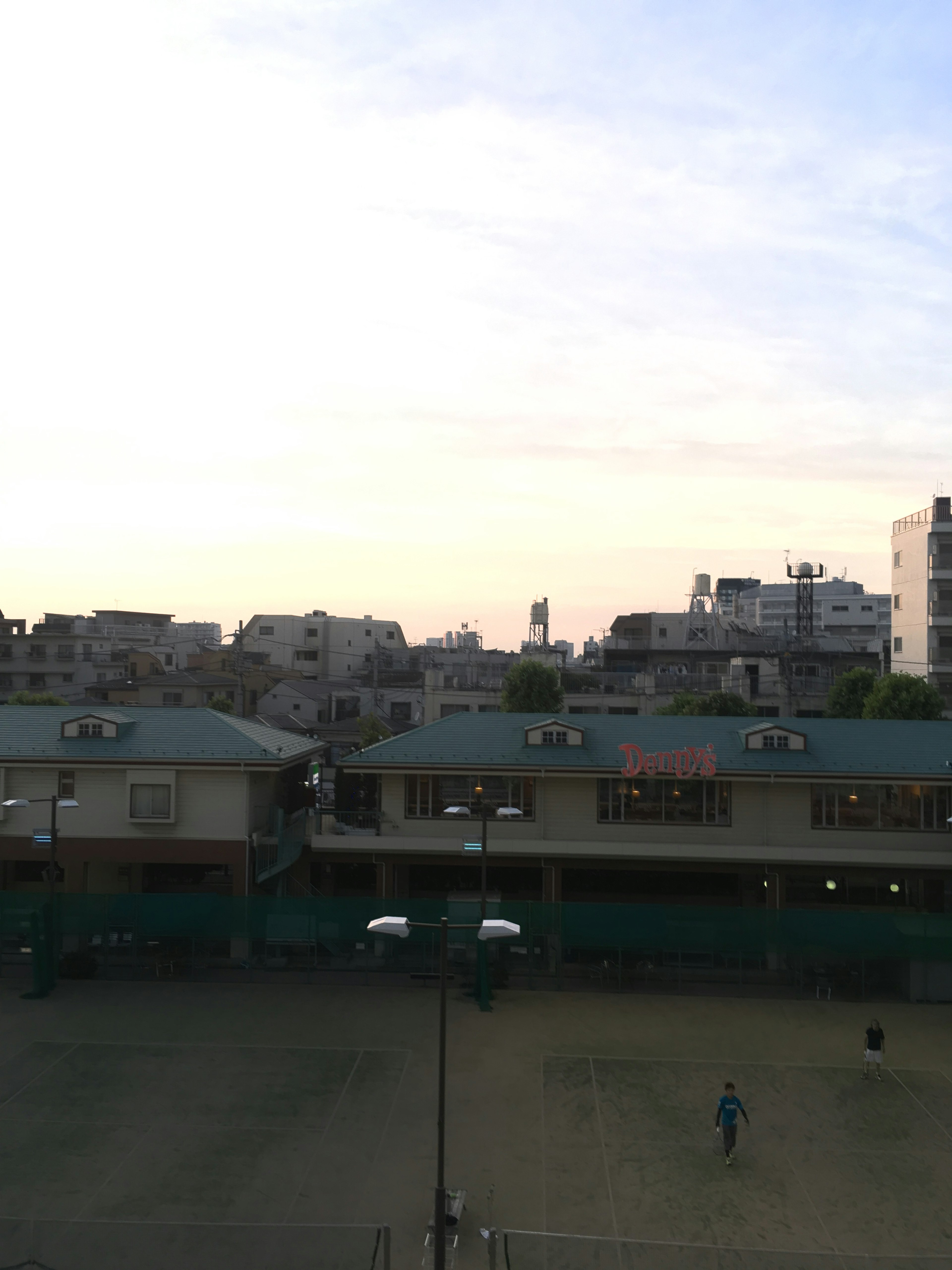 Cityscape with buildings under a pastel sky at dusk