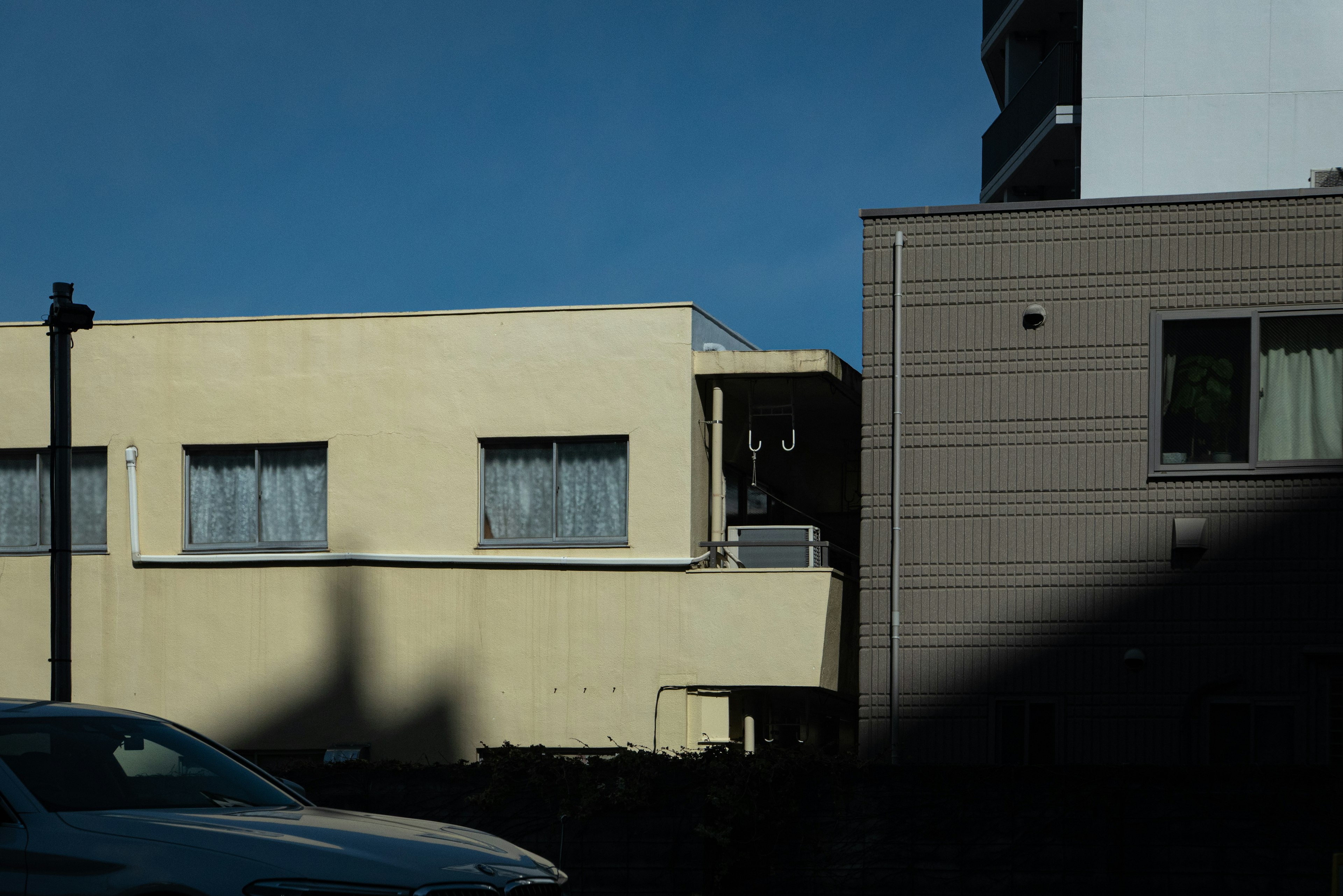 urban scene featuring a yellow building adjacent to a brown building