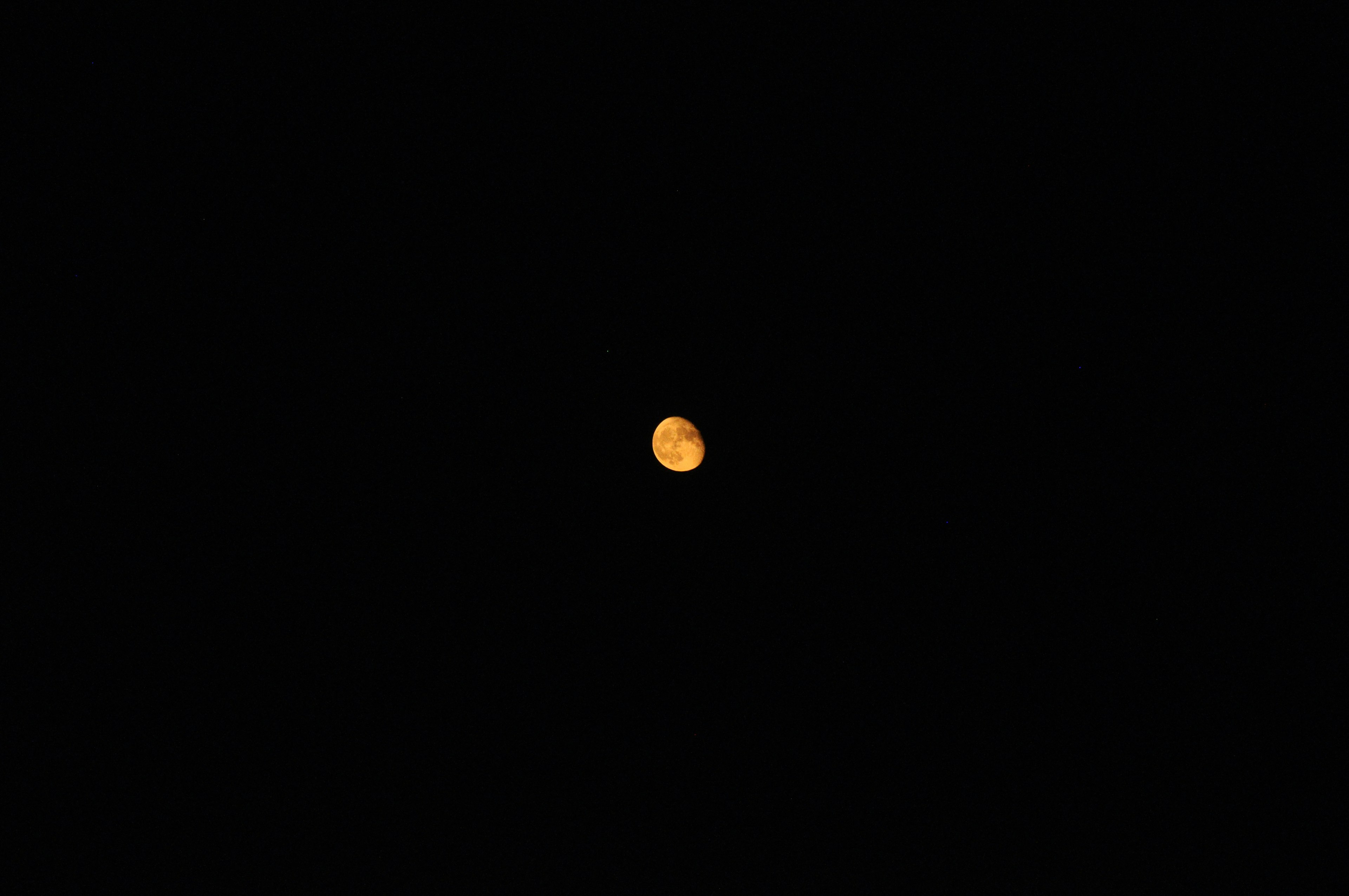 Orange circular celestial body against a dark background