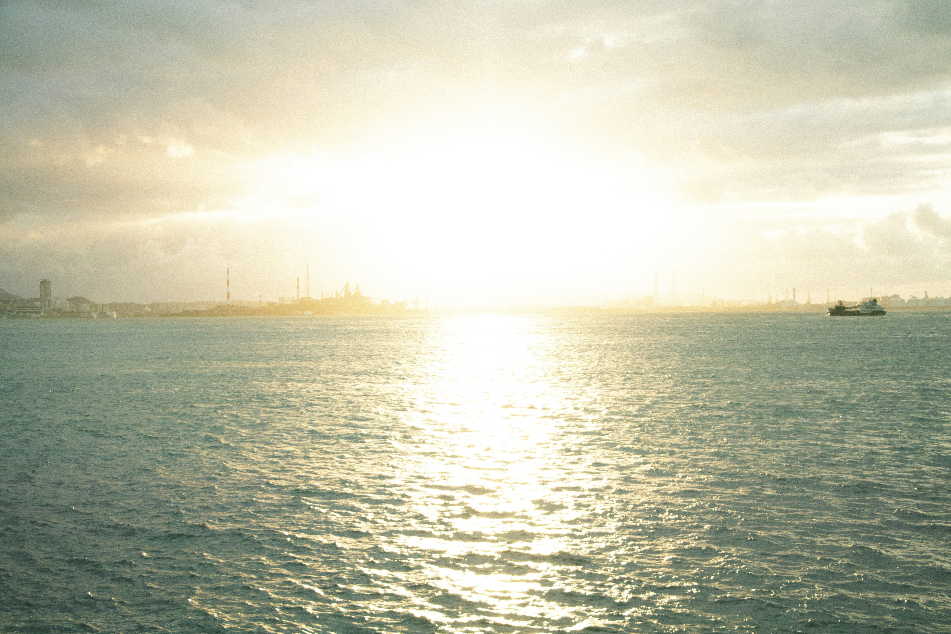 Shimmering sunset over the ocean with gentle waves