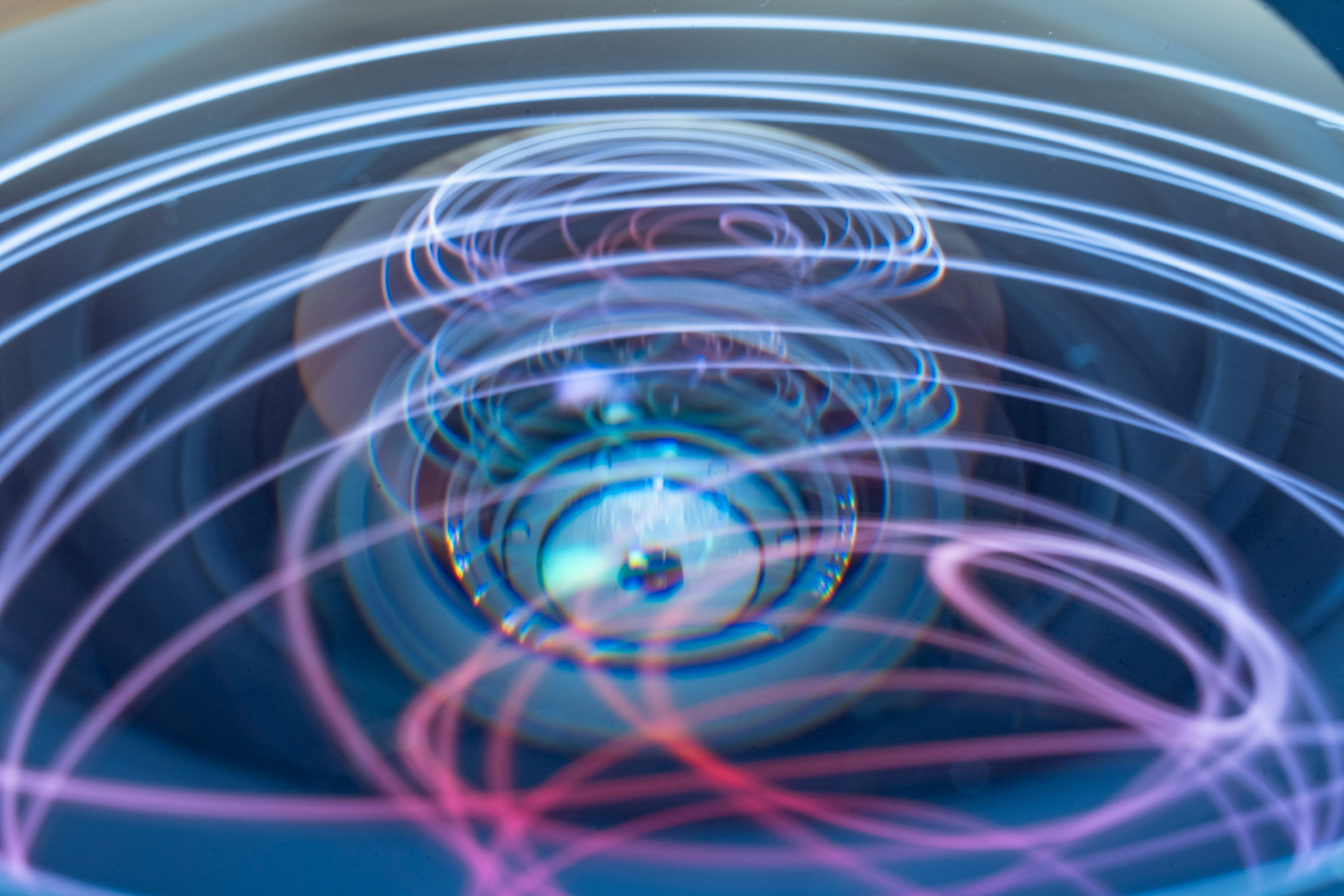 Abstract image of colorful swirling lights around a lens