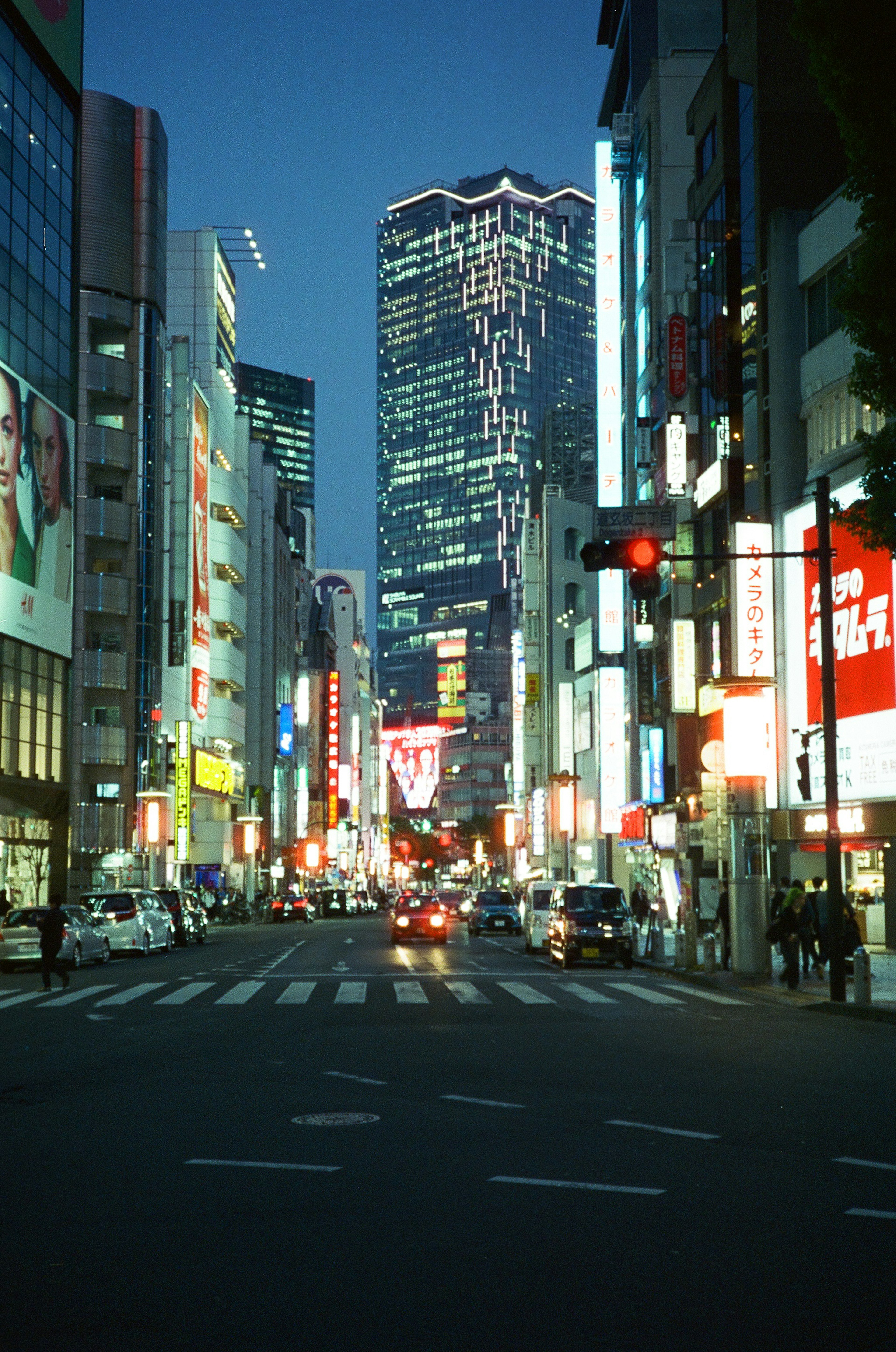 Cityscape at night featuring tall buildings and bright lights