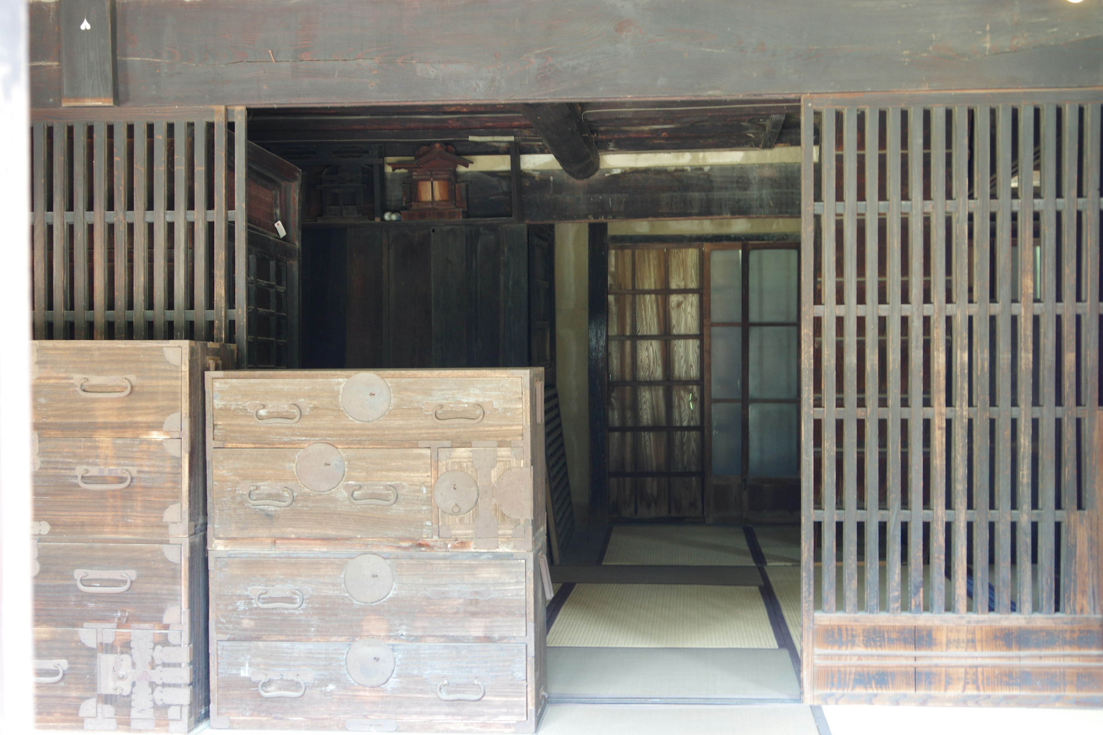 Entrance of a traditional Japanese room with wooden sliding doors and tatami flooring