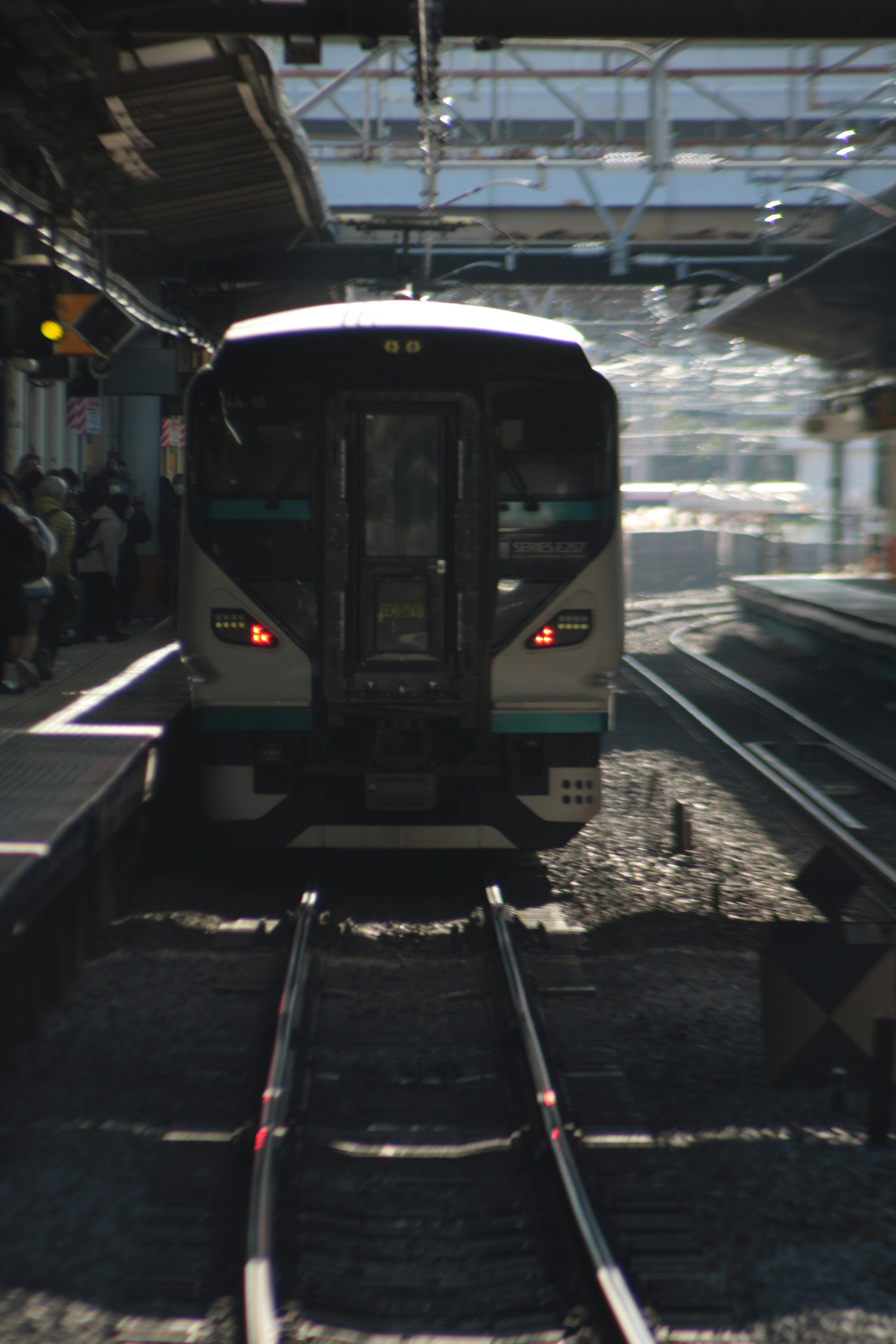 Train at a station with visible tracks and platform