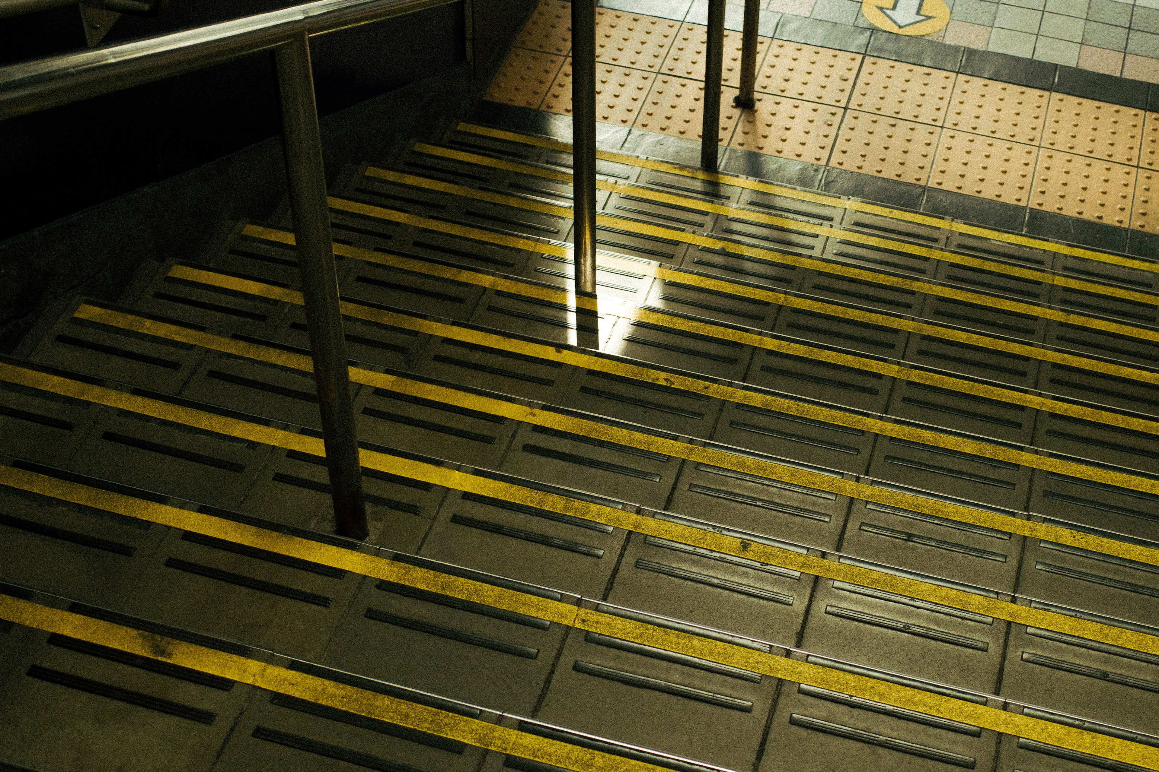 Staircase with yellow safety stripes on the steps