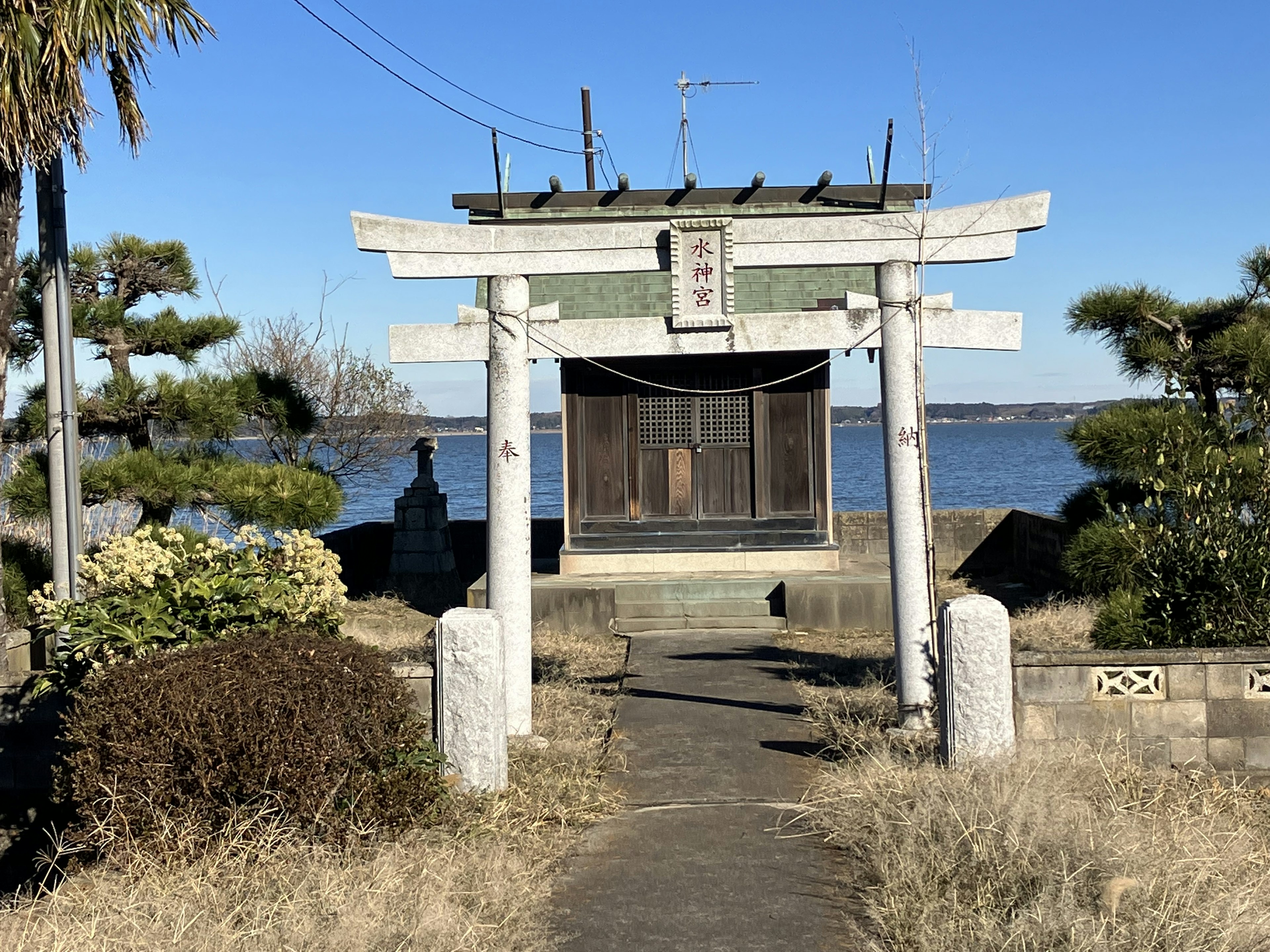 Traditional shrine gate and building by the water