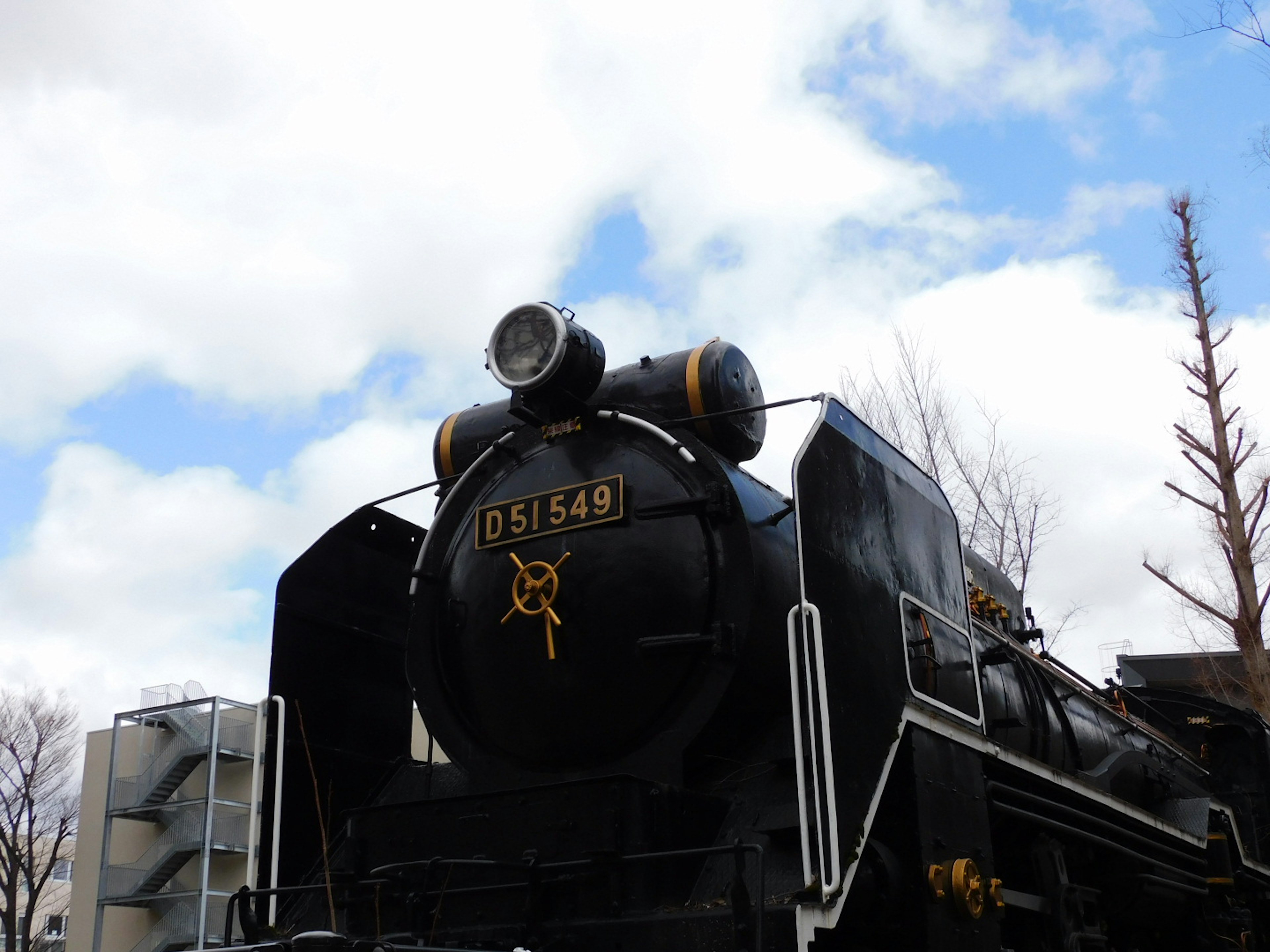 Black steam locomotive with number 05149 against a blue sky