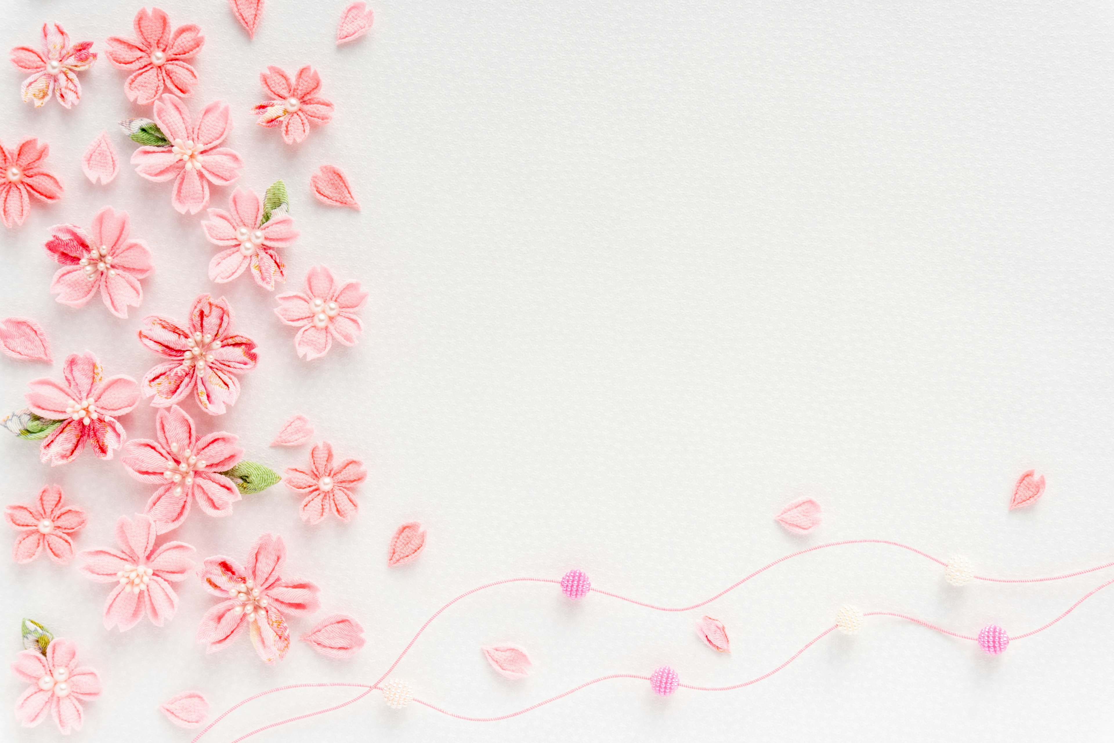 A soft pink flower arrangement on a white background