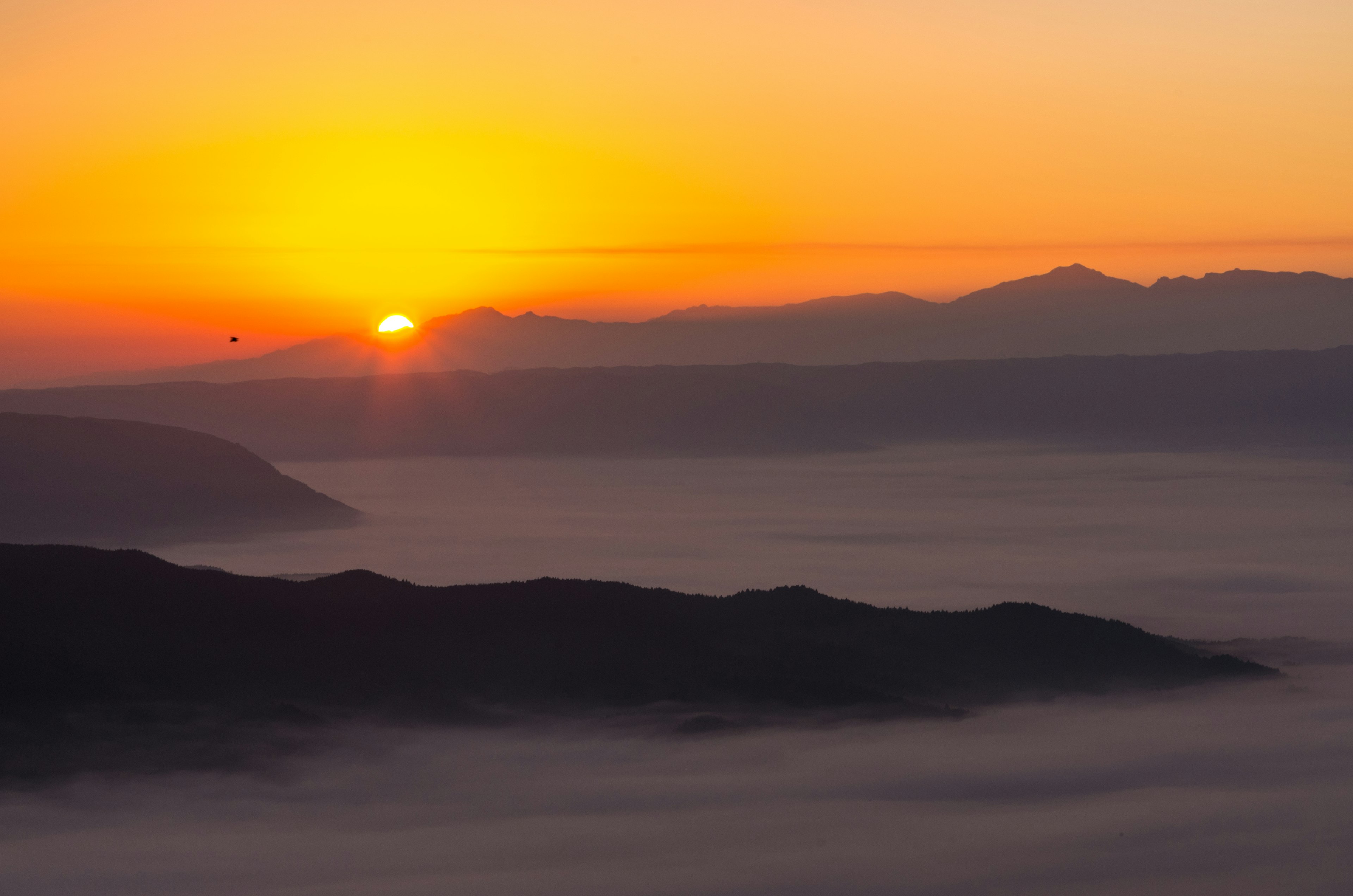 朝日が山々の間から昇る美しい風景