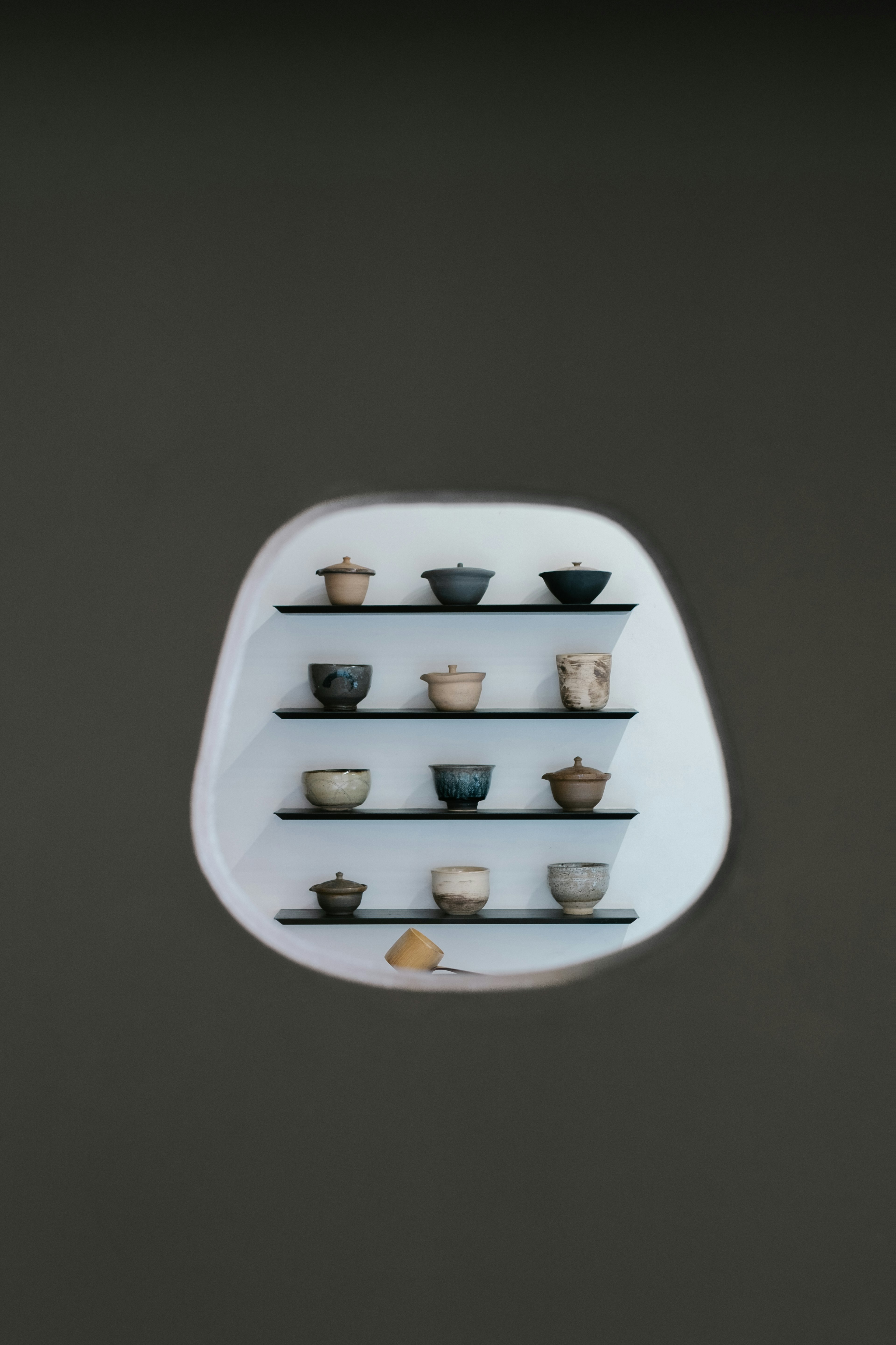 Display of ceramic bowls arranged on white shelves