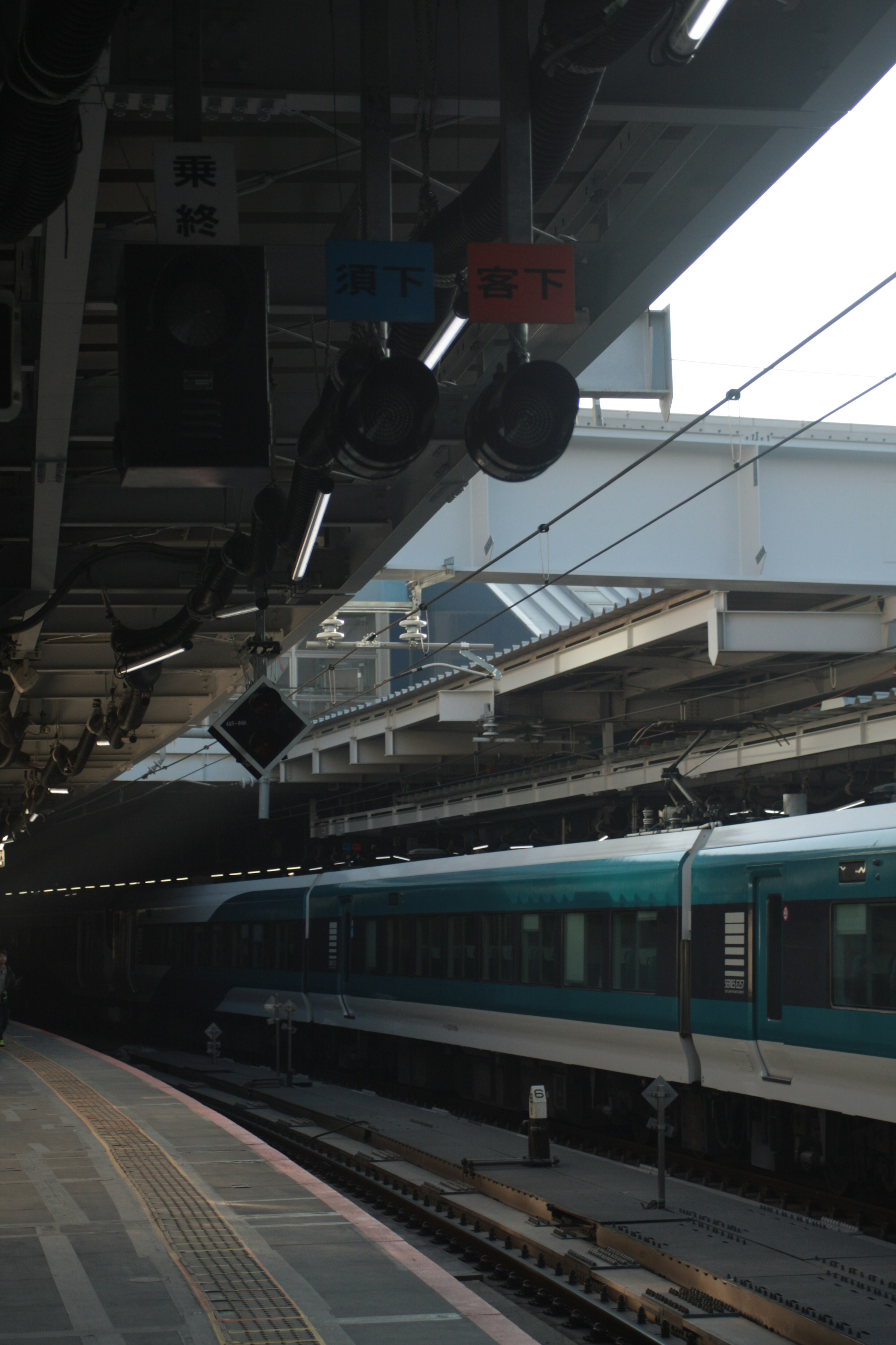 Train at a railway station platform with signal lights